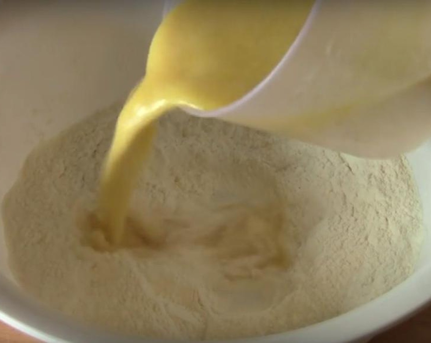 step 2 In a bowl, prepare the dry ingredients: Self-Rising Flour (2 cups), Caster Sugar (1/2 cup) and Salt (1 pinch). Stir them together, and pour in the wet ingredients. Stir until they combine.