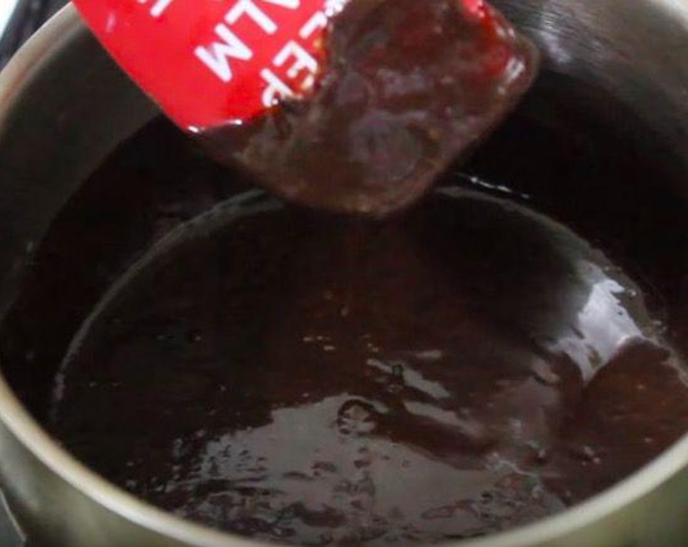 step 6 In a heavy-bottomed saucepan, add Mini Marshmallows (1 cup), Milk (4 Tbsp), Semi-Sweet Chocolate Chips (2/3 cup), Vanilla Extract (1/2 tsp). Melt together until mixture is smooth. Set aside to cool.