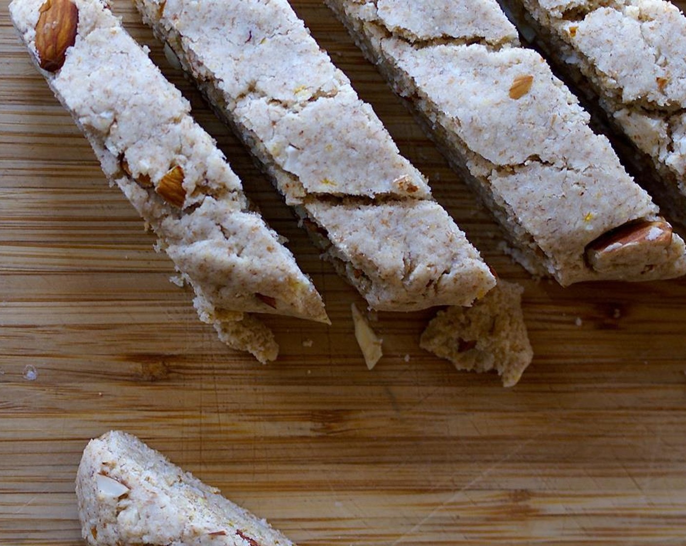 step 9 Cut the end off each dough log, diagonally. Proceed to cut each log into 1/2 inch slices, following the first diagonal cut. Lay the biscotti on a parchment lined sheet and bake for 10-15 more minutes.