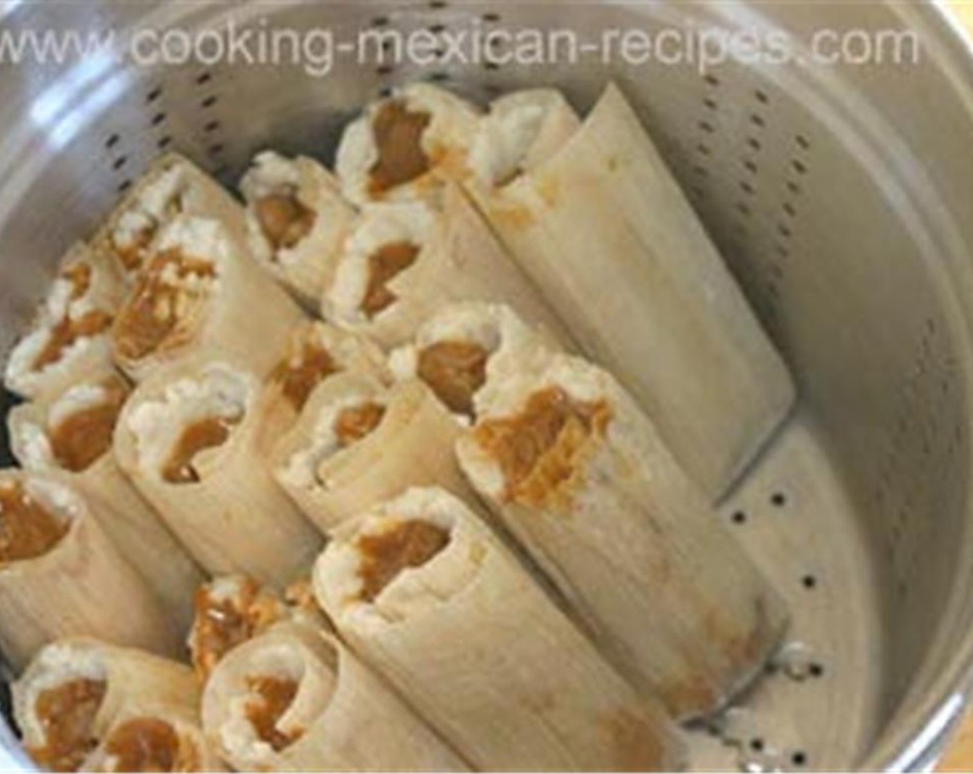 step 10 Place a damp cotton towel over the top of the tamales, and cover with the lid. Add just enough water to the bottom of the pan so that the water doesn't touch the tamales. Check this water often to make sure it doesn't all evaporate.