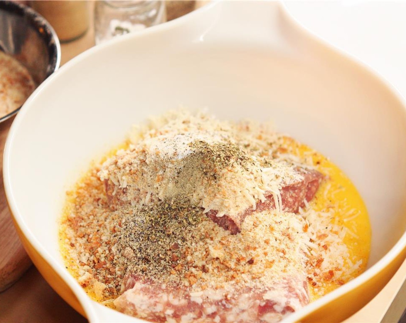 step 1 In a large bowl, combine Ground Beef (1 lb), Ground Pork (1 lb), Breadcrumbs (1 1/2 cups), Eggs (4), Parmesan Cheese (1/2 cup), Garlic Powder (1 tsp), Ground Black Pepper (1 tsp), Salt (1/2 tsp), and Dried Oregano (1/2 tsp). Mix well, using your fingers or a fork.