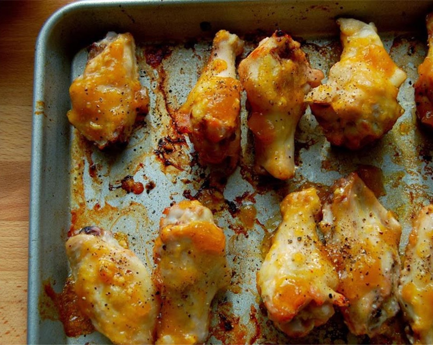 step 4 Remove from oven. Brush the wings with half of the mango chipotle mixture. Reserve the other half for dipping later.