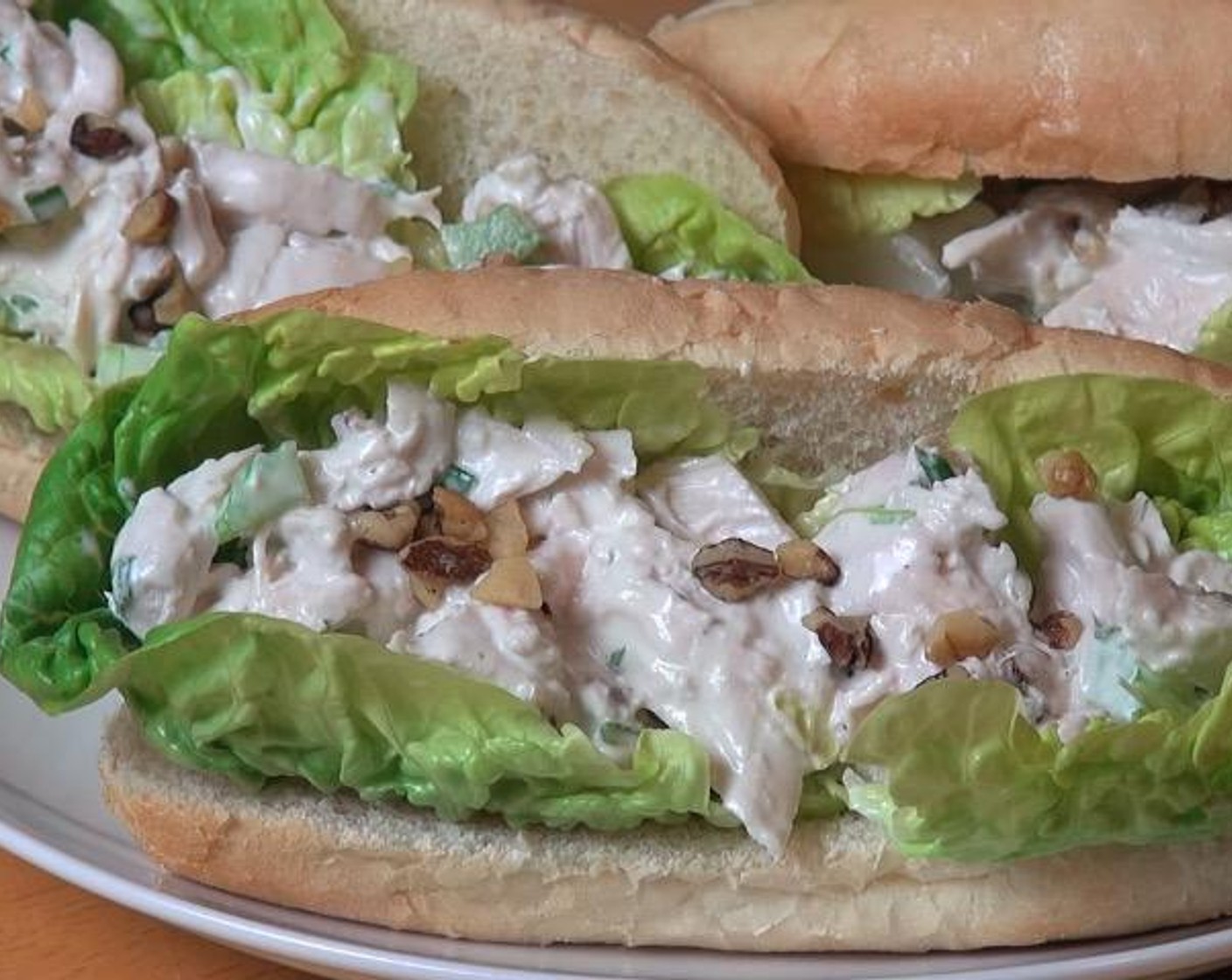 step 4 For each sub, slice a Sub Rolls (to taste) in half. Add Lettuce (to taste), chicken mixture and additional Walnuts (to taste). Serve and enjoy!