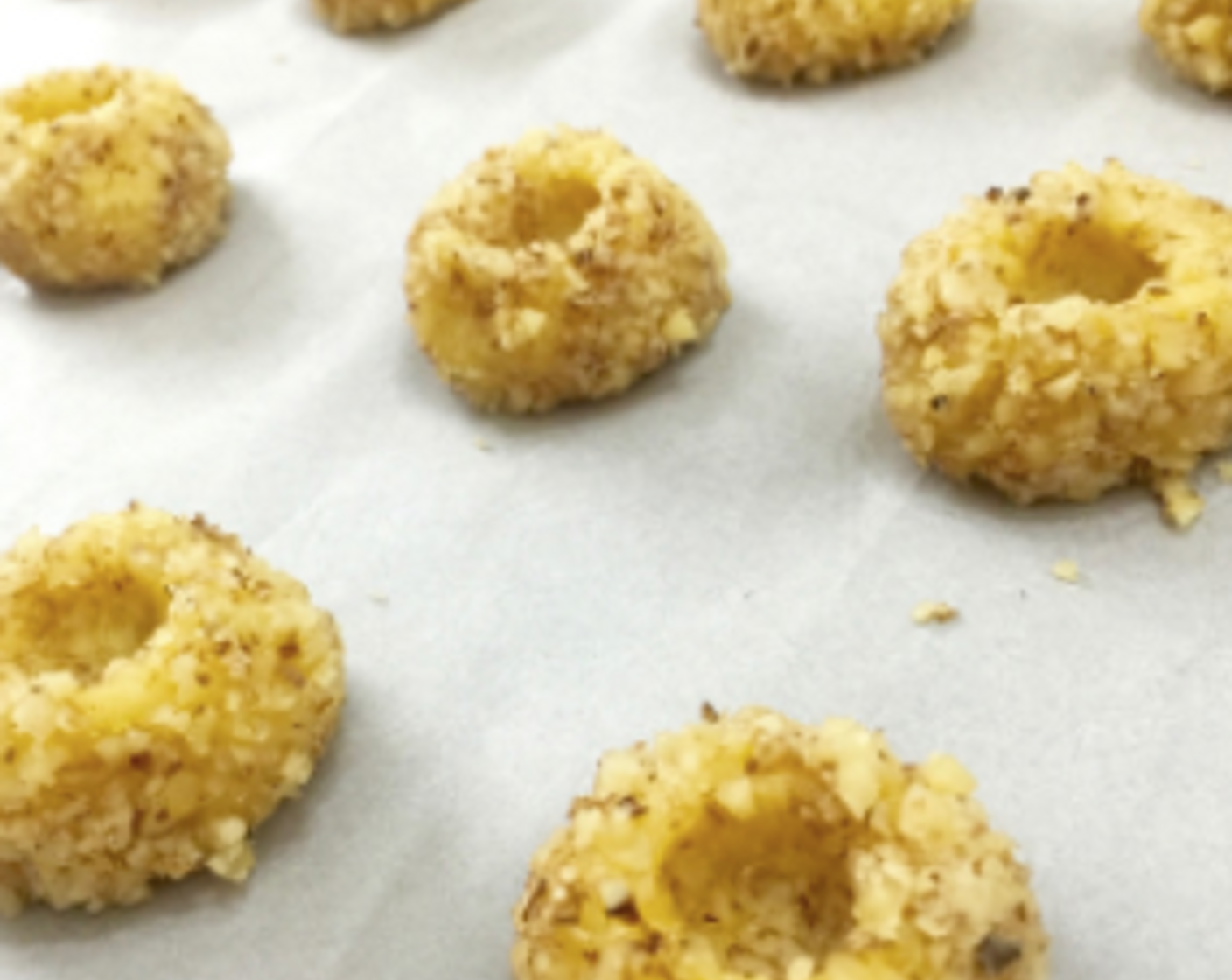 step 23 Next, using your thumb or something round, make an indentation into the centre of each cookie dough.