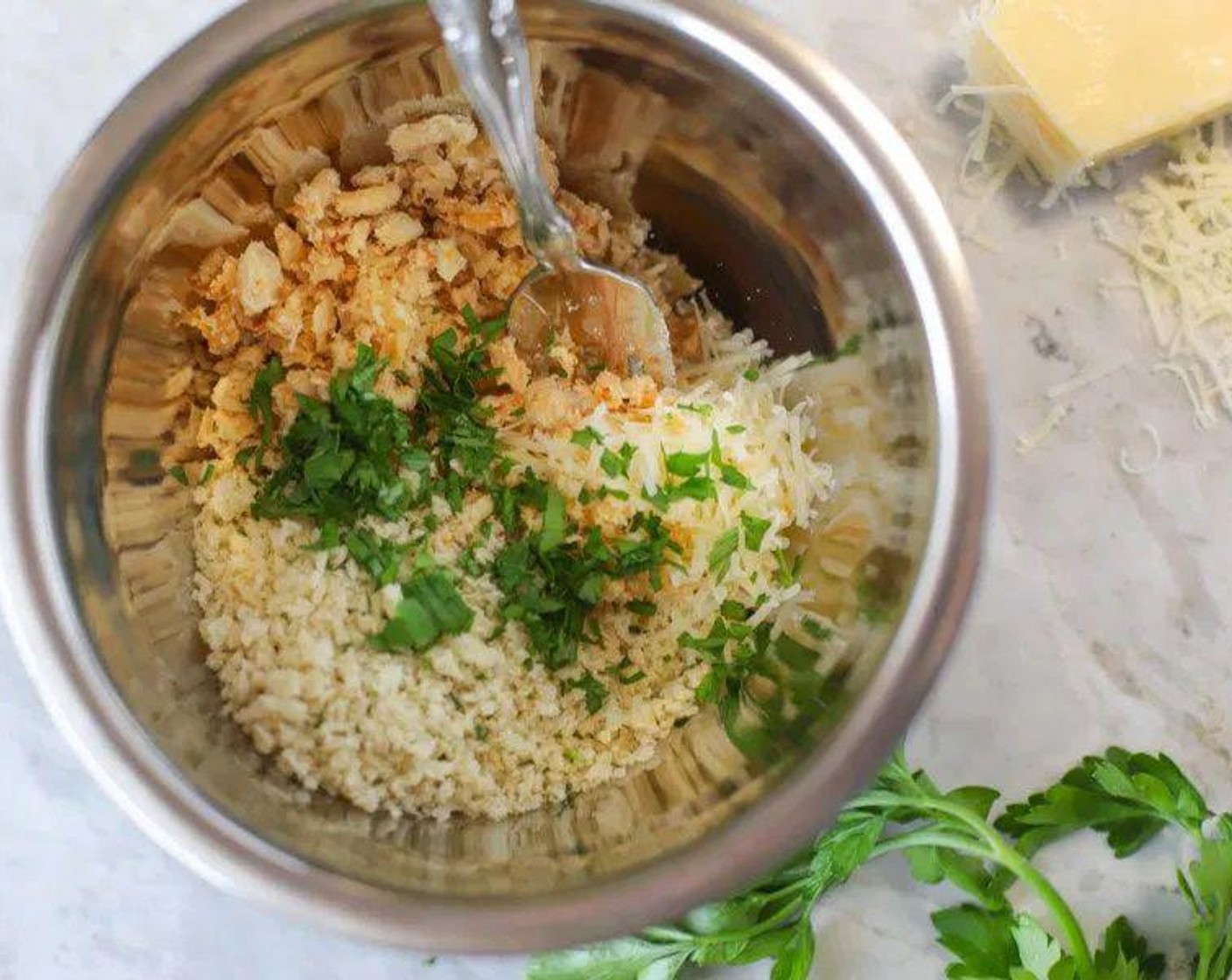 step 3 Meanwhile, prepare the crust topping. In a small bowl, measure out Fried Onions (2/3 cup) and crush into fine pieces with a fork. Add Seasoned Panko Breadcrumbs (2/3 cup), Parmesan Cheese (4 Tbsp), and Fresh Parsley (1 tsp) to bowl and mix until combined. Set aside.