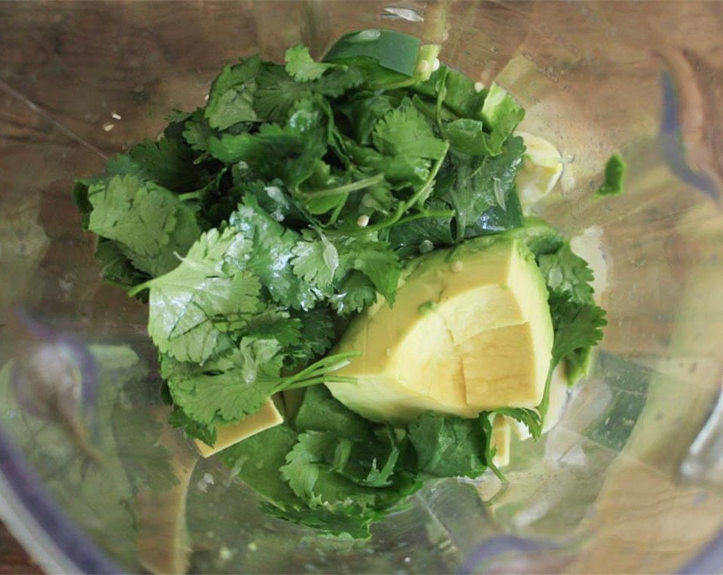 step 5 Add the tomatillos, Avocado (1), Garlic (2 cloves), Jalapeño Pepper (1) along with the Fresh Cilantro (4 Tbsp) into a food processor. Juice one Lime (1) into the food processor, add a pinch of Salt (1 pinch) and Extra-Virgin Olive Oil (1 Tbsp).