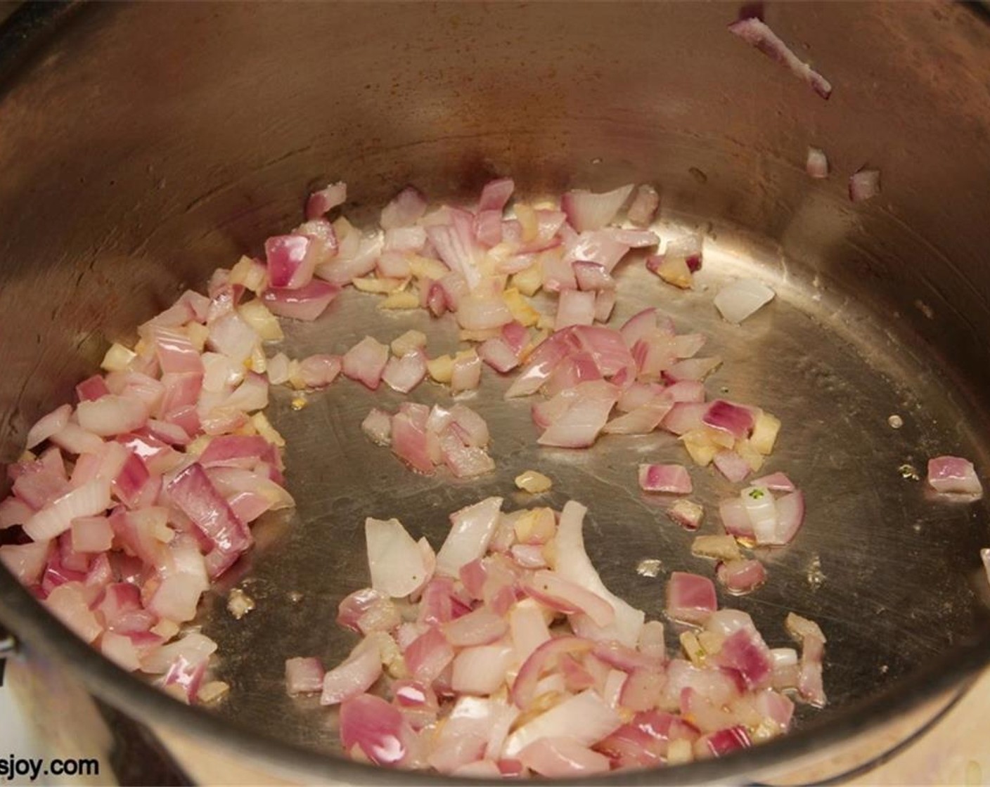step 1 Heat the Olive Oil (2 tsp) in a pot and add the Onion (3/4 cup) and Garlic (2 cloves). Sauté until the onions are cooked.