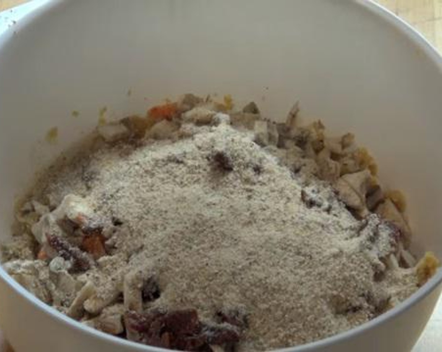 step 1 Into a bowl, add the Canned Chickpeas (2 cups) and gently mash them with a spoon. To that, add and mix the Garlic (1 clove), Carrot (1), Button Mushrooms (3), Sun-Dried Tomatoes (4 Tbsp),Eggs (2) Ground Coriander (1 tsp), Paprika (1/2 tsp),Breadcrumbs (1 cup), Salt (to taste) and Ground Black Pepper (to taste).