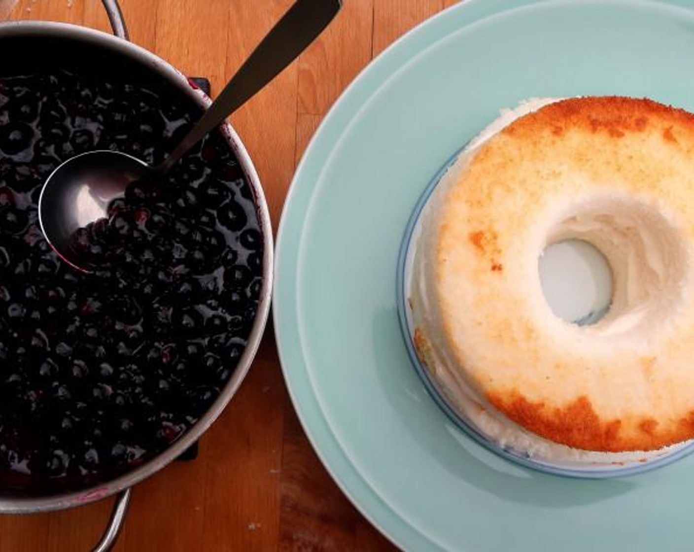 step 6 Fill the hole in the center of the cake with blue berry compote. If you value “Yummy” and abundance over beauty, pour more blueberries around the cake. Decorate with pomegranate seeds and a small bouquet of flowers.