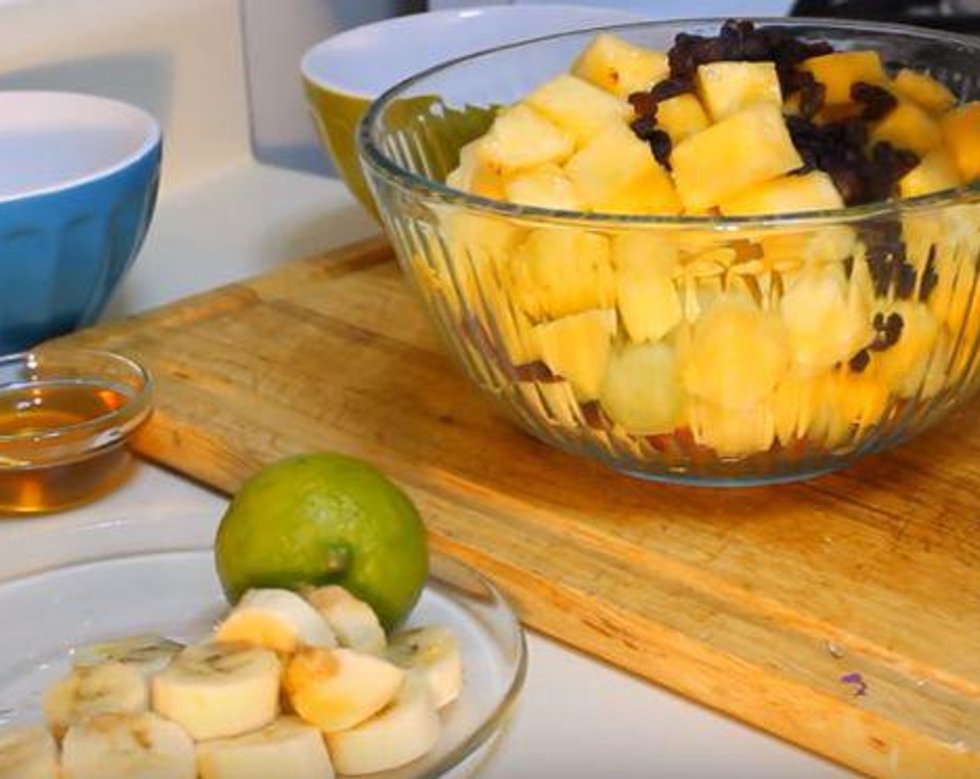 step 1 Add the Mangoes (2), Pineapples (2 cups), Honeydew Melons (2 cups), Banana (1), Raisins (4 Tbsp), and Apple (1) to a large bowl.