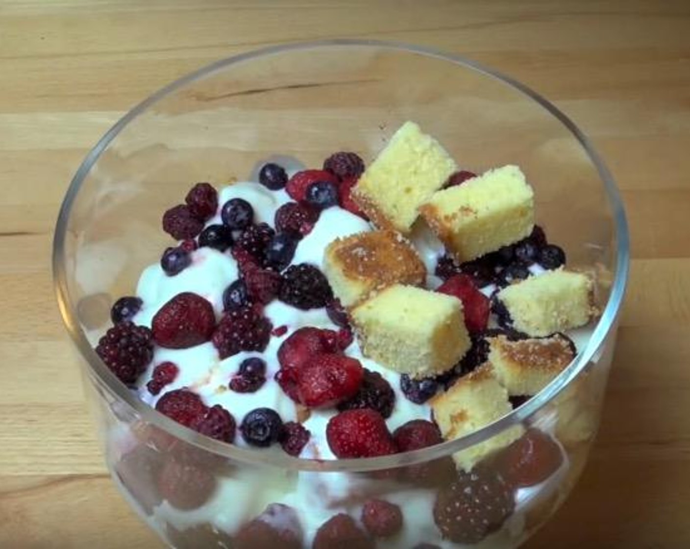 step 2 Scatter half of the Plain Cake (1.1 lb) over the bottom of a serving bowl. Spoon over half of the orange juice mixture. Pour half of the Vanilla Yogurt (4 cups) over top. Spread half of the Fresh Mixed Berries (2 3/4 cups) over top. Repeat the layers once more.