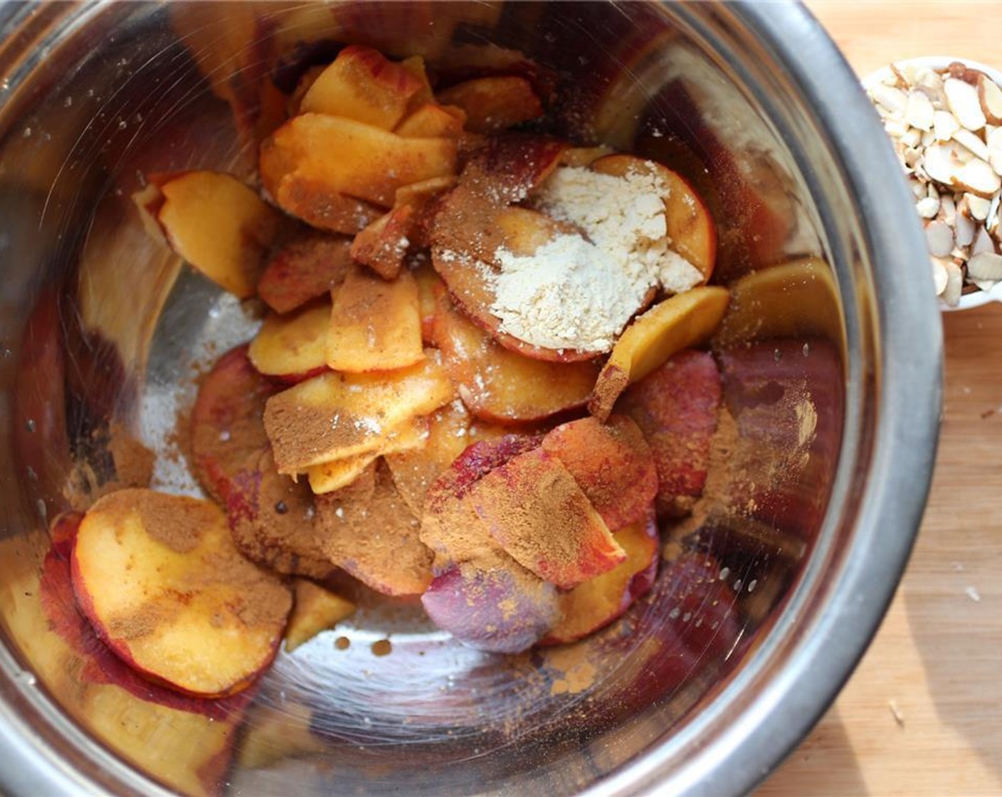step 3 In a large bowl, add the peaches, Ground Cinnamon (1/2 tsp), Vanilla Extract (1/2 tsp), Chickpea Flour (1 Tbsp), juice from Lemon (1), Agave Syrup (1 tsp), and Salt (1 pinch). Mix well but ensure the peaches stay intact.