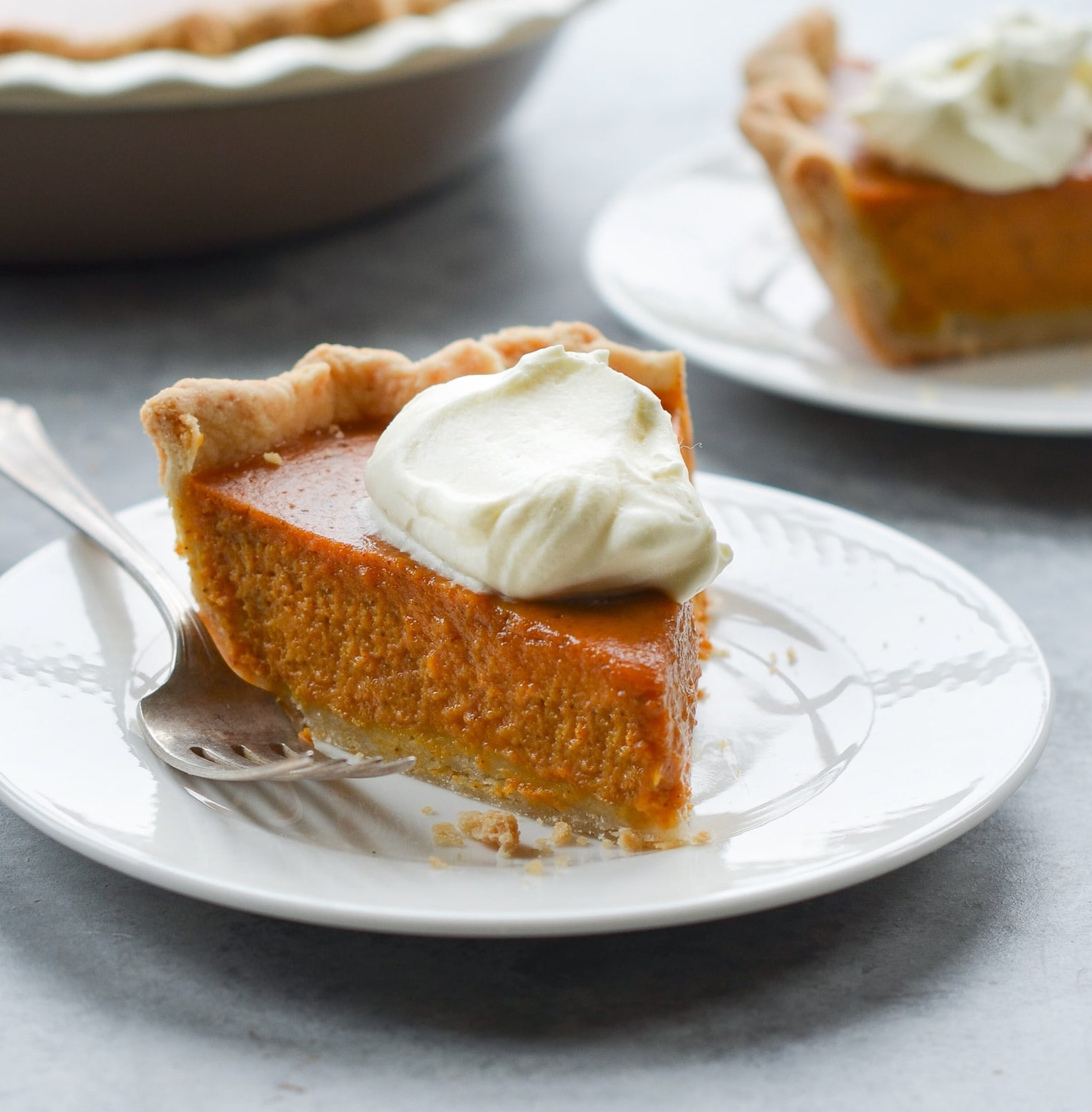 A slice of classic pumpkin pie, an easy fall dessert recipe.