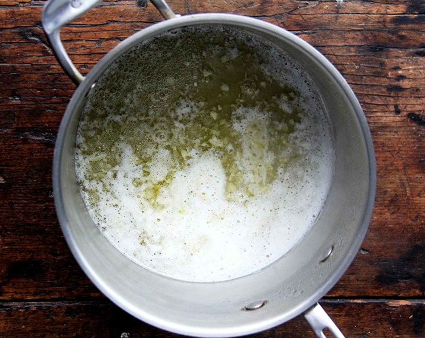 step 5 In a large heavy saucepan, cook Garlic (1 clove) in Unsalted Butter (4 Tbsp) over moderately low heat, stirring, until softened.