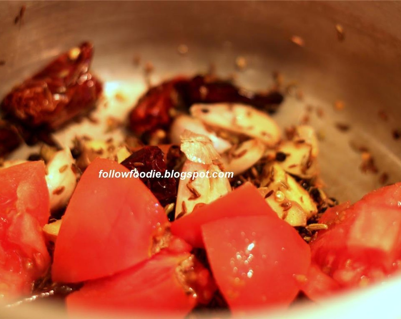 step 4 In a pressure cooker, add Oil (2 Tbsp) Fry the Red Chili Peppers (15), Cumin Seeds (1 Tbsp), Peppercorns (2 tsp), Fennel Seeds (1 tsp), ginger, chopped tomatoes and Garlic (8 cloves). Cook until the tomatoes are mushy.