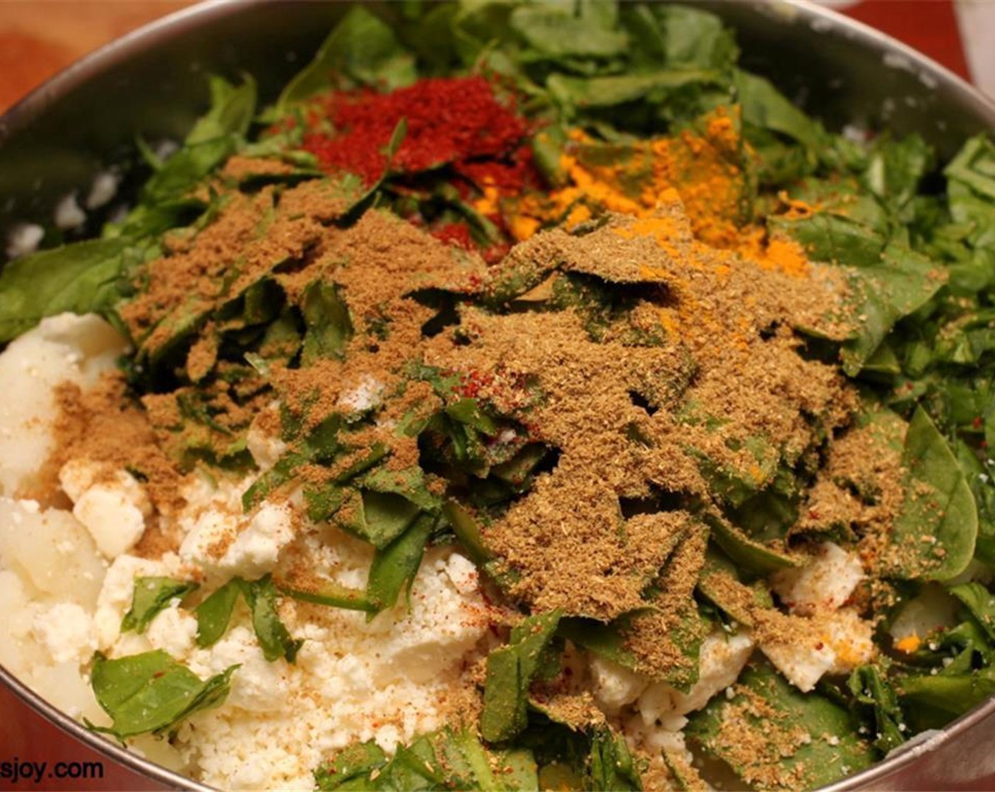 step 2 Mix with Fresh Spinach (2 cups), Chili Powder (1 tsp), Feta Cheese (1/2 cup), Ground Coriander (2 tsp), Ground Cumin (1/2 tsp), Salt (to taste), and Ground Turmeric (1 pinch). Set filling aside.