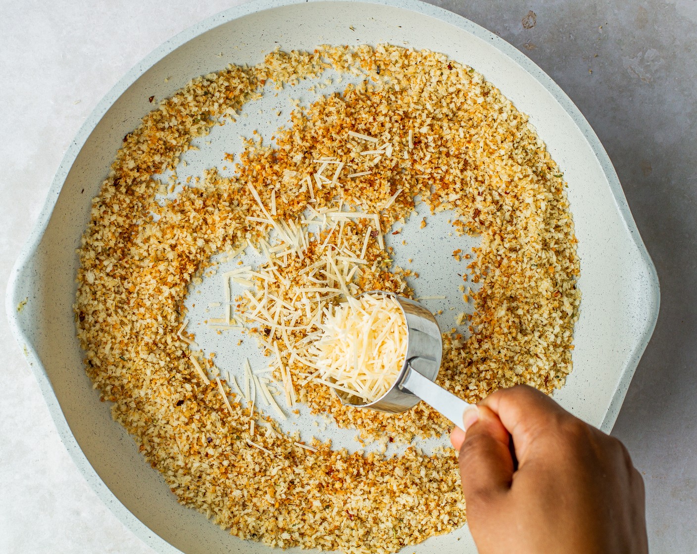 step 2 Remove from the heat and stir in Shredded Parmesan Cheese (4 Tbsp). Transfer toasted breadcrumbs to another vessel and set aside.
