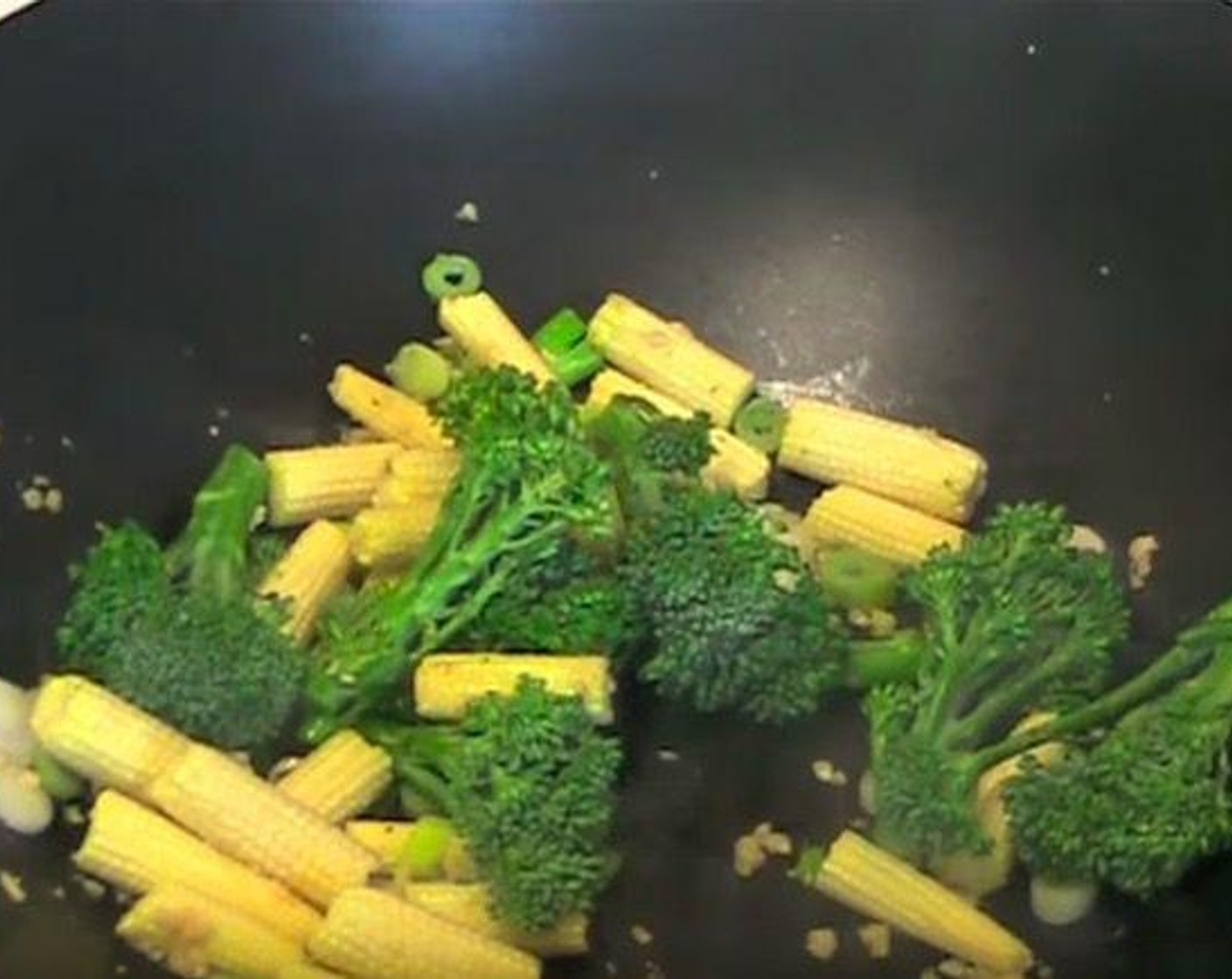 step 3 Into the same wok, add Scallion (1 bunch), Broccolini (1 cup), and Baby Corn (1 cup). Cook for 3 minutes, or until vegetables are warmed through.