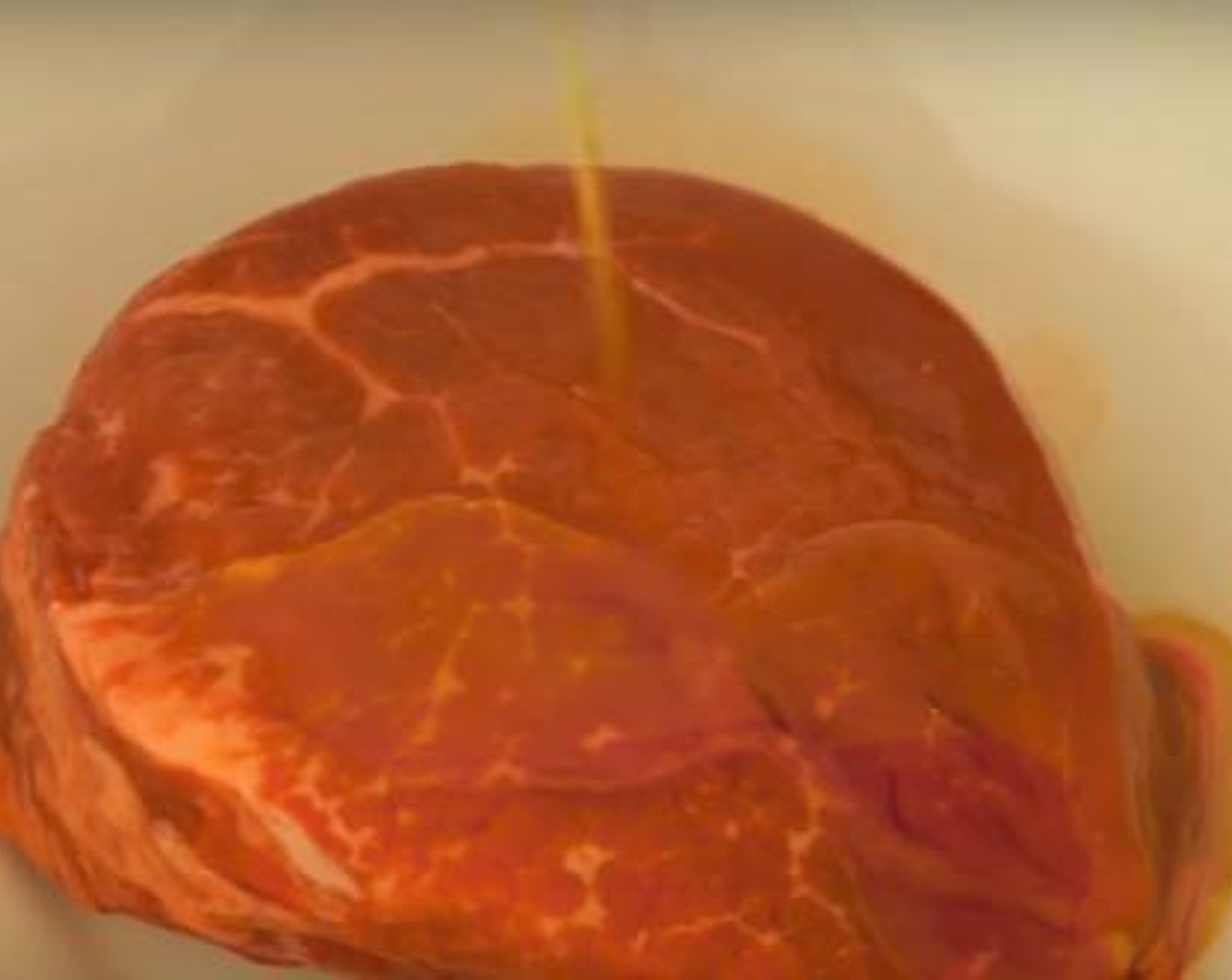 step 2 In a large bowl, marinate your Angus Eye Filet (7 oz) in Extra-Virgin Olive Oil (as needed) and a sprinkle of Salt (to taste) and Ground Black Pepper (to taste). This should be left outside of the fridge to reduce to room temperature for approximately 20 minutes.