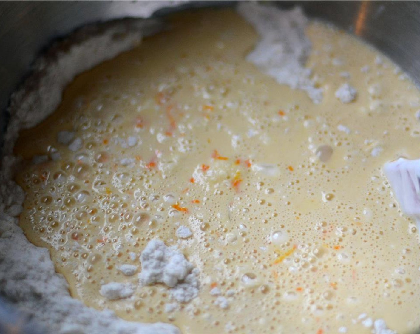 step 4 In a medium-sized bowl, whisk together the zest and juice from the Oranges (3), Eggs (2), Sour Cream (1/3 cup), and Vanilla Extract (2 tsp). Pour into the flour mixture and mix gently until just combined.