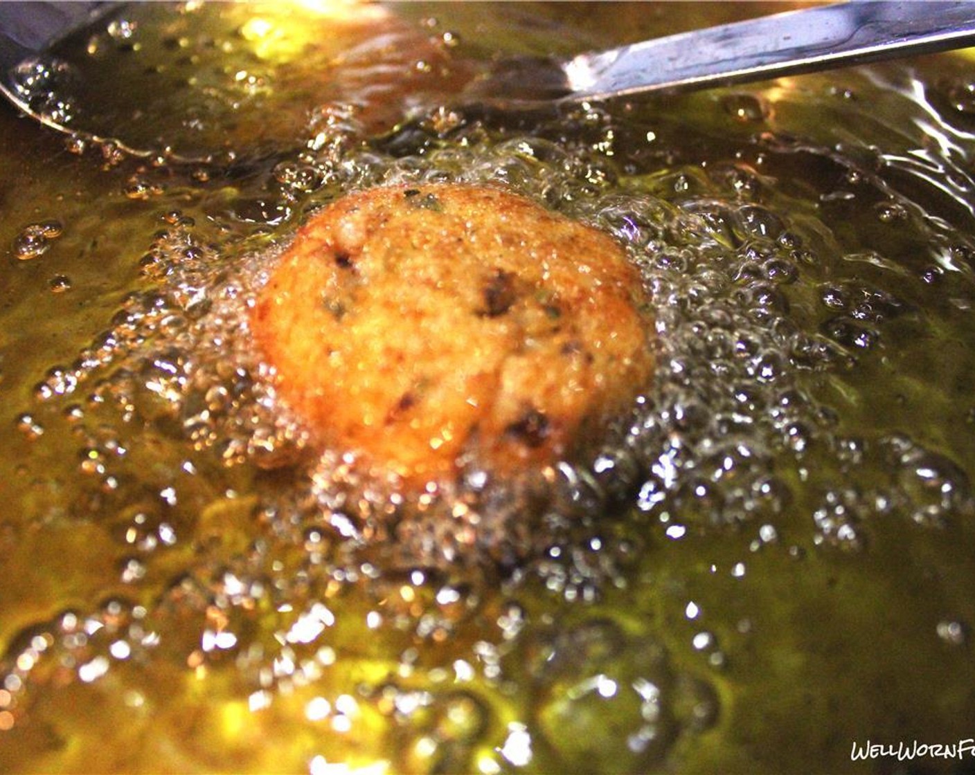 step 9 Put a few of rice balls in the oil at a time and stir consistently. Take out once golden brown and salt immediately. Repeat with remaining rice balls.