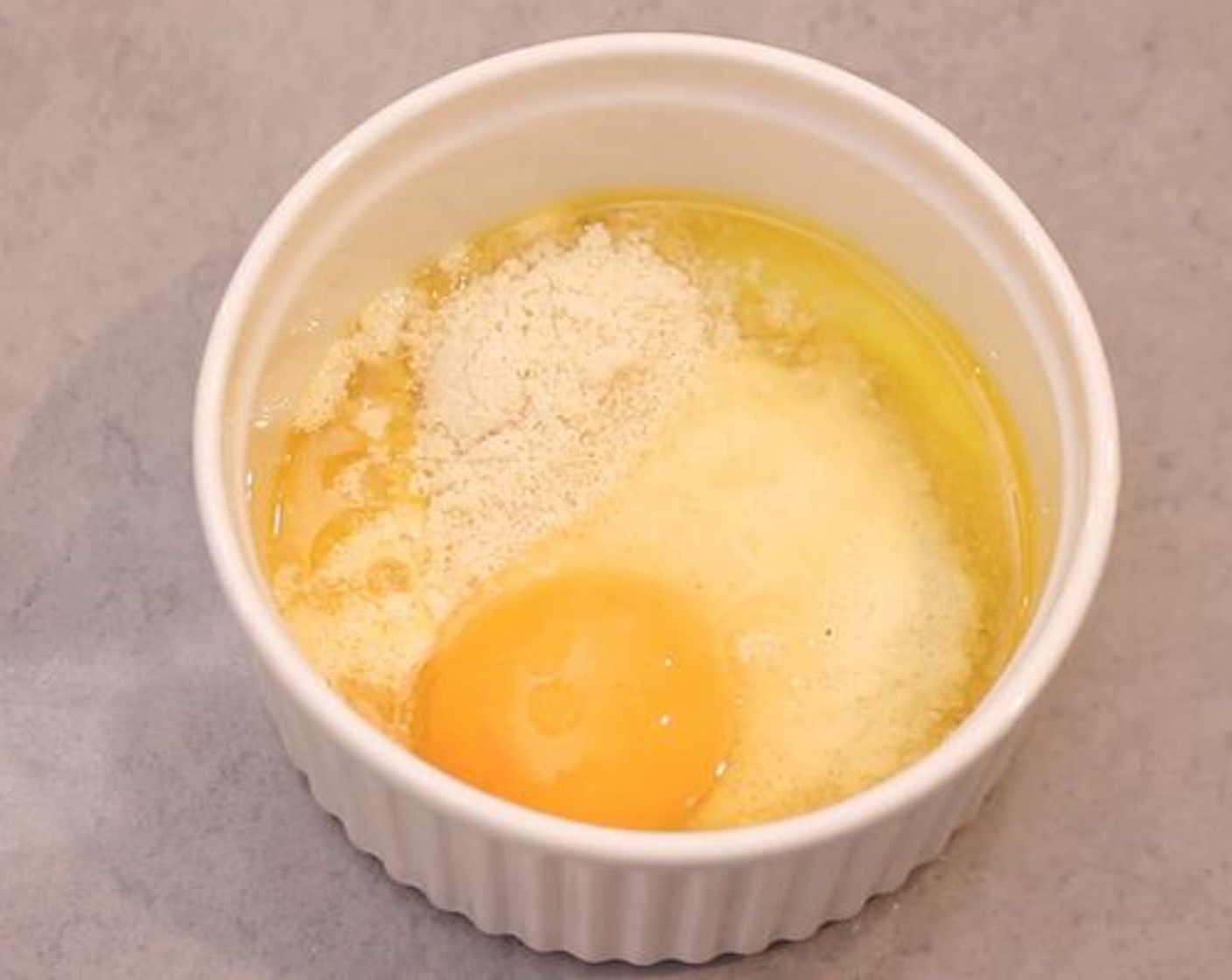 step 2 Once melted add the Baking Powder (1/2 tsp) which will help the bread rise, then add in the Almond Flour (3 Tbsp) and finally your Egg (1). Mix everything together really well until you have a lump free batter.