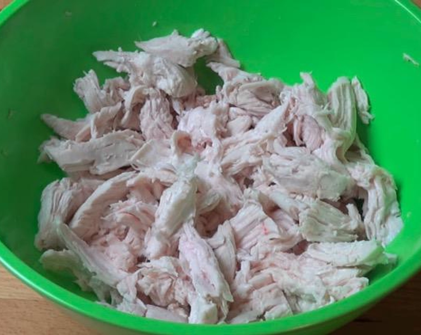 step 2 Remove chicken to a mixing bowl. After chicken has cooled slightly, use a couple of forks to shred it into pieces.