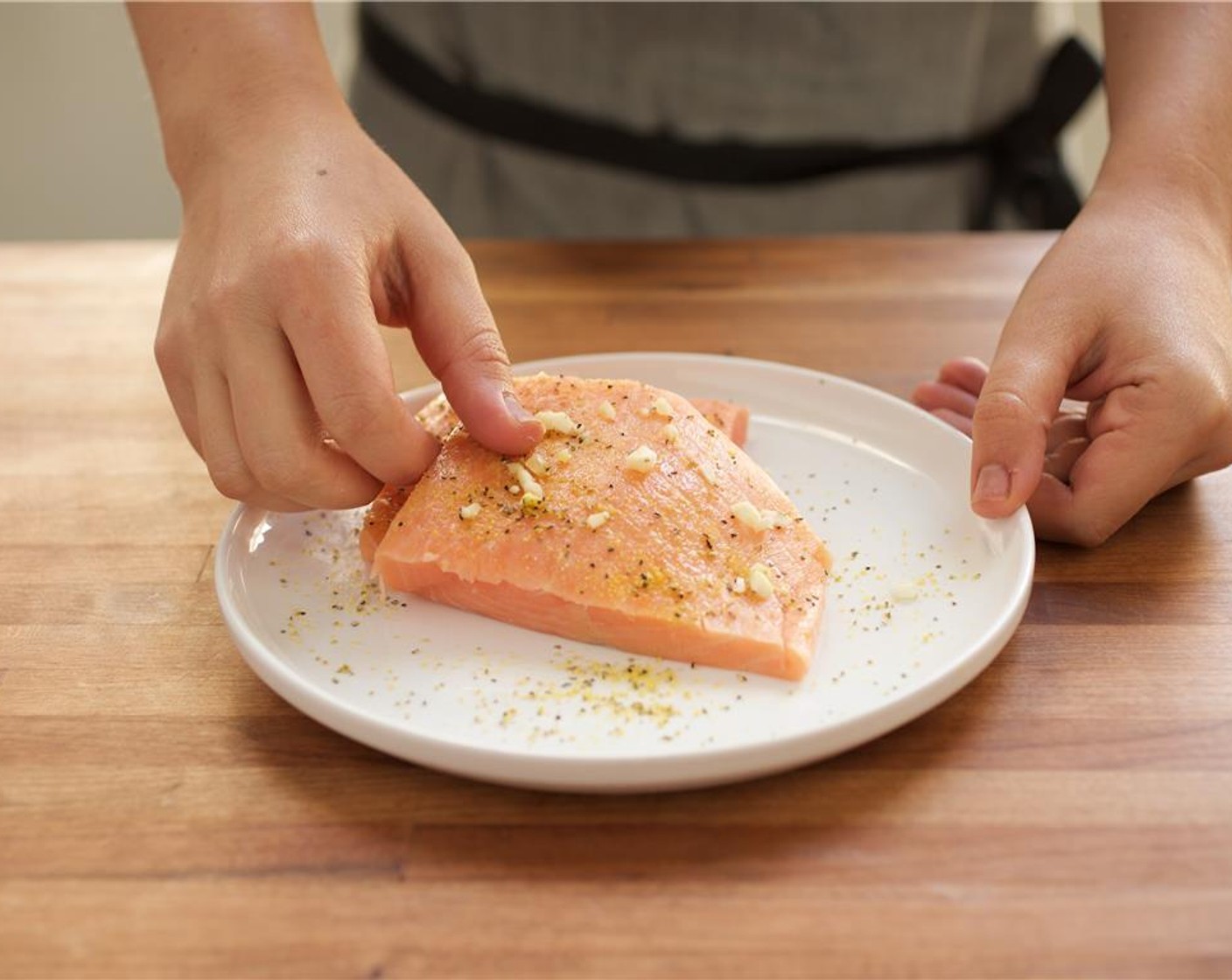step 10 Pat dry Salmon Fillets (2) with paper towels. On a plate, season each fillet with a quarter teaspoon of Lemon Pepper (1/2 tsp), Salt (to taste), and chopped garlic. Set aside.