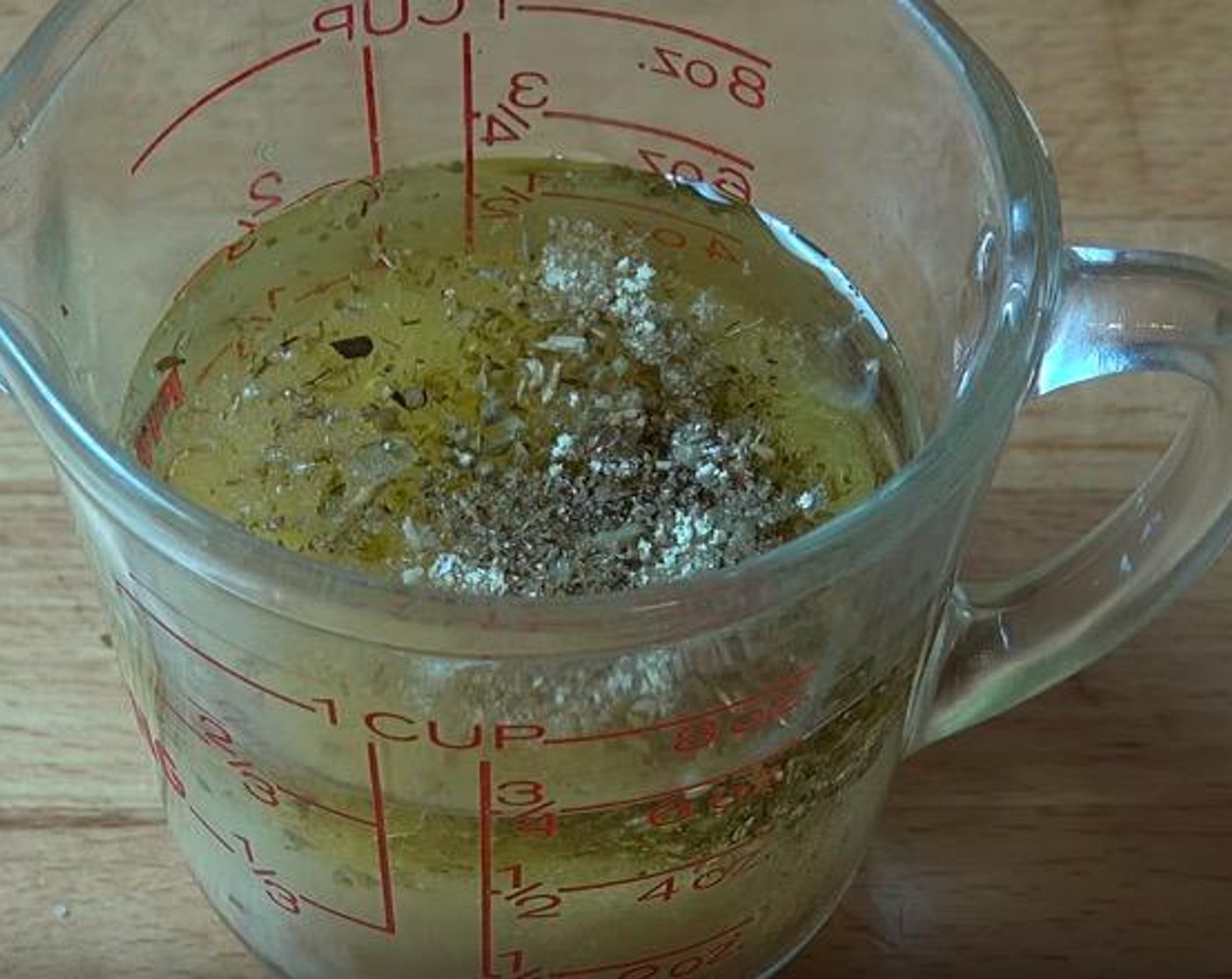 step 1 In a small jug, add Olive Oil (4 Tbsp), the juice from Lemons (2), Dried Oregano (1 tsp), Onion Powder (1 tsp), Garlic (2 cloves), Salt (1 tsp), and Freshly Ground Black Pepper (to taste). Stir together.