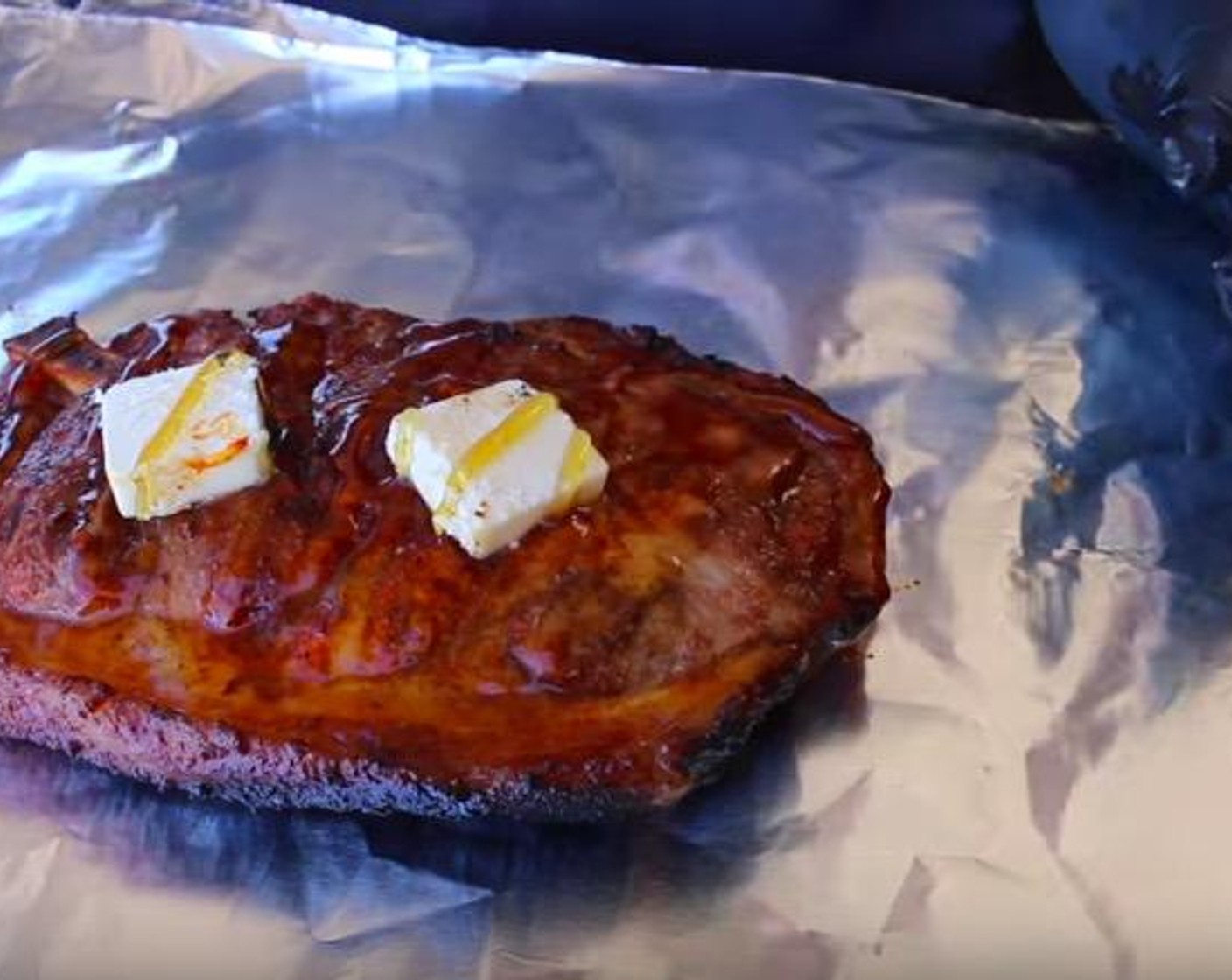 step 4 Place pork steaks individually on a sheet of aluminum foil. Cut Salted Butter (1/2 cup) into 8 pieces and top pork steaks with 2 pats each. Pour Honey (4 Tbsp) evenly over the pork steaks. Wrap completely in foil and return pork steaks to the raised cooking rack.
