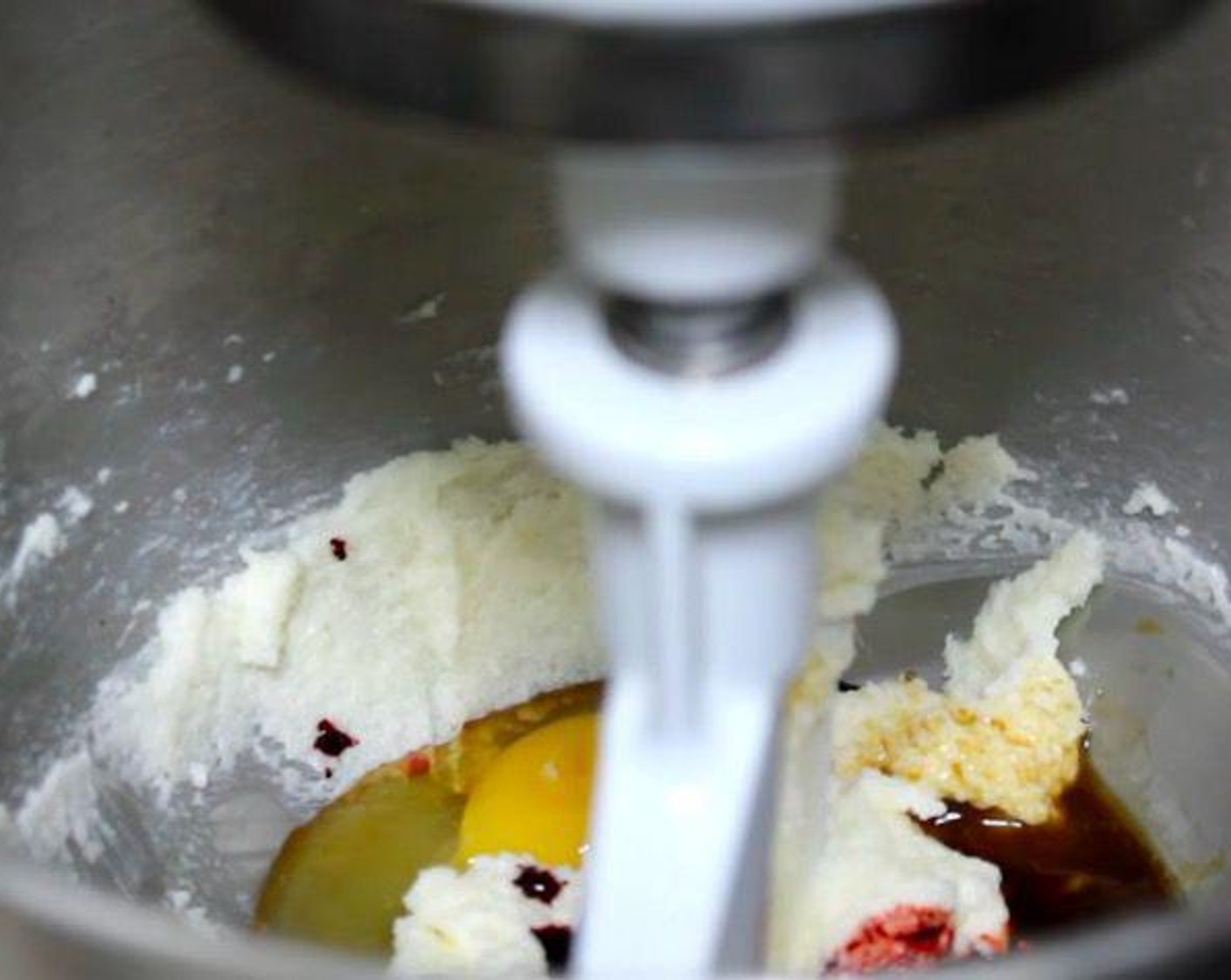 step 1 In the bowl of a stand mixer, add Granulated Sugar (1 cup) and Butter (2/3 cup) and mix until smooth. Add Large Egg (1), Vanilla Extract (1 tsp), and Red Food Coloring (1 Tbsp). Mix again until combined.