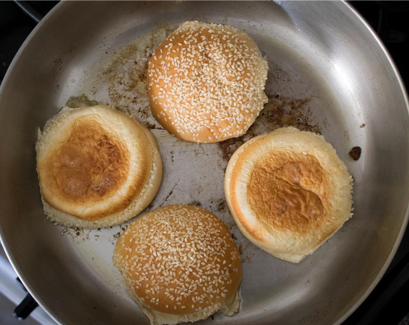 step 8 With the remaining oil in the pan, toast the Sesame Hamburger Buns (4) for 1 minute. Add more oil if needed.