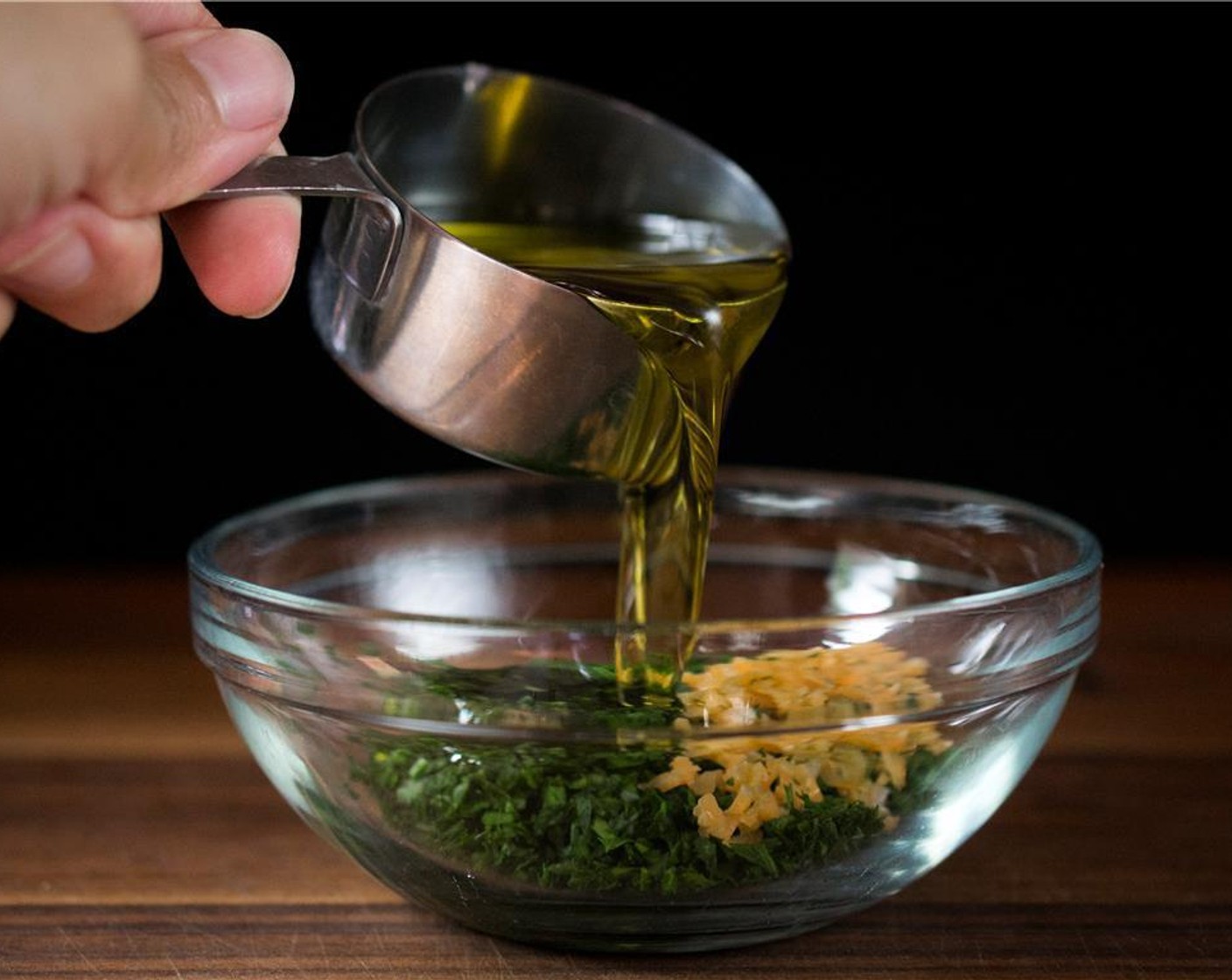 step 4 As the meatballs are baking, prepare the Parsley-Chili Oil simply by mixing Italian Flat-Leaf Parsley (4 Tbsp), Habanero Pepper (1), Olive Oil (1/2 cup), and Kosher Salt (1 tsp) in a medium sized bowl. Whisk until well incorporated.