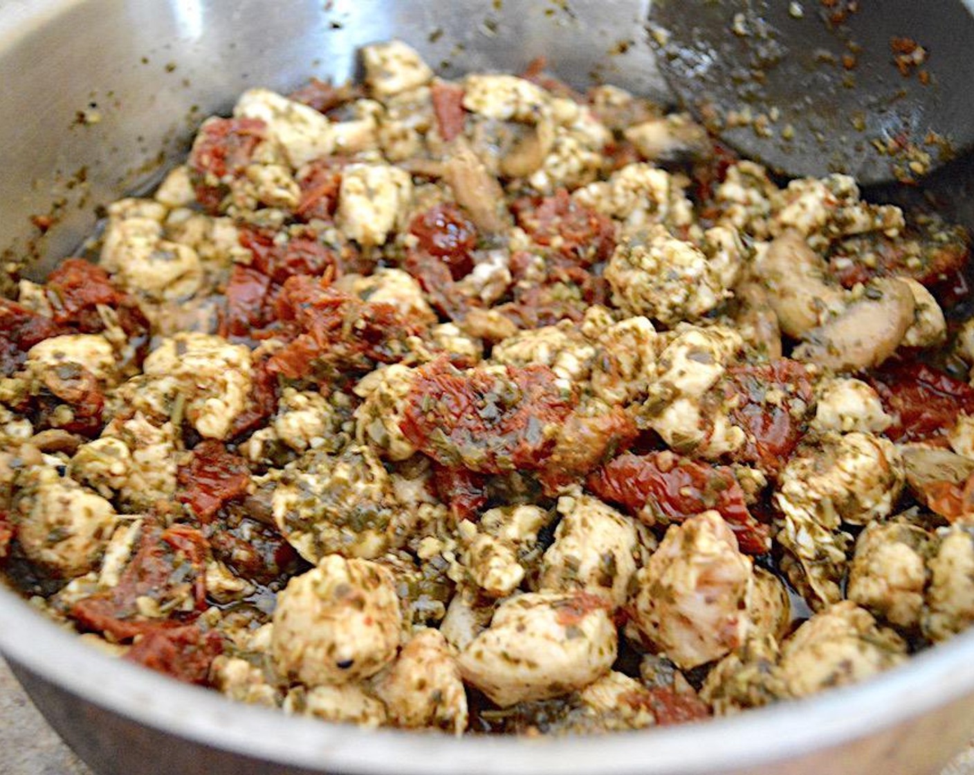step 4 Add the Boneless Skinless Chicken (1 lb) and let it completely cook while you stir it well. Season the entire mixture with Salt (1 pinch), Freshly Ground Black Pepper (1 pinch), Garlic Powder (1 pinch), and Dried Parsley (1 pinch). Once the chicken is cooked through, add the Basil Pesto (1 cup) and let it all gently simmer together on low for 5 minutes. Take it off of the heat and set it aside.