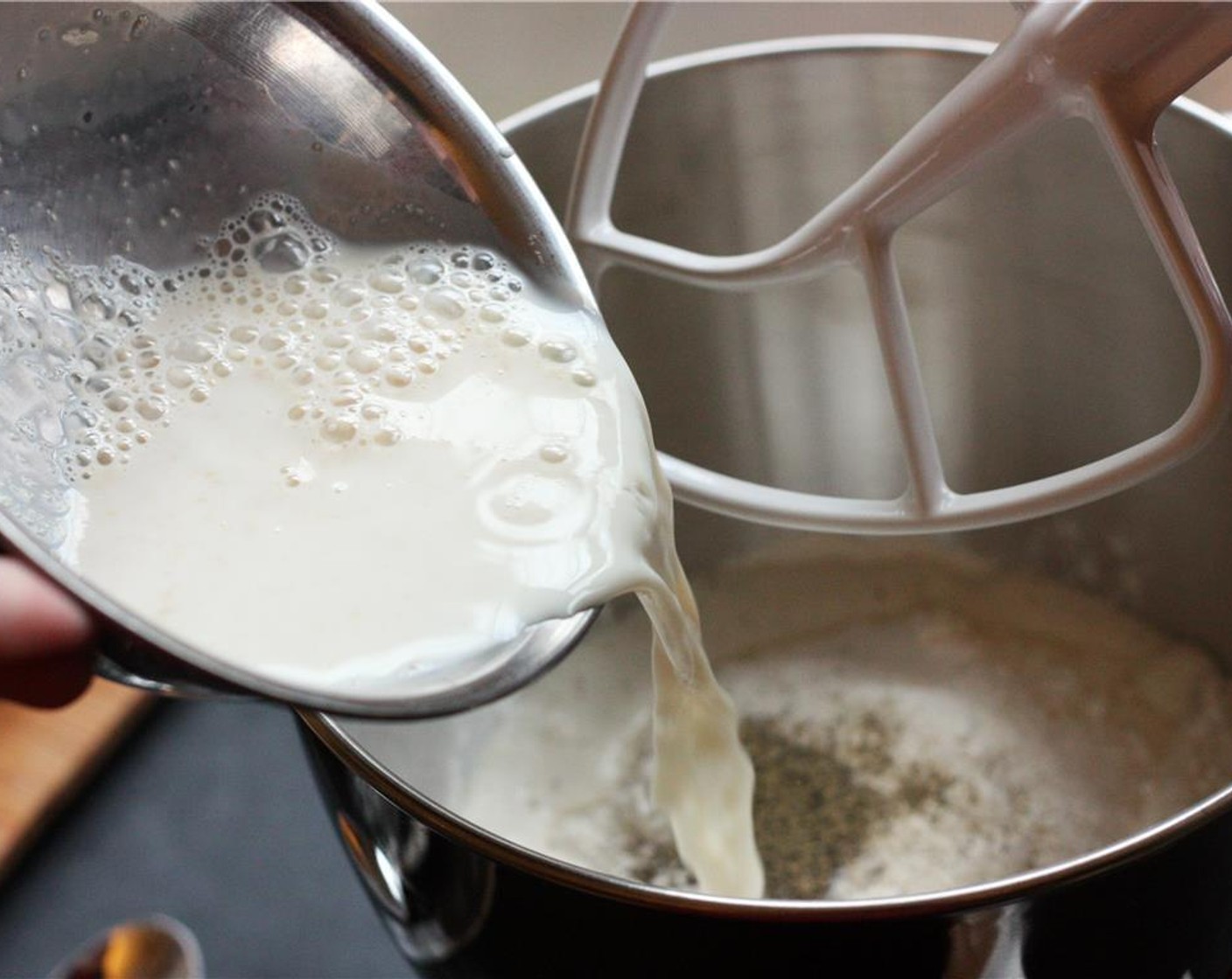 step 2 In a separate bowl, whisk together the Instant Dry Yeast (2 tsp) and Milk (1 cup) until yeast is dissolved. Add the yeast mixture and Butter (4 Tbsp) to the mixer bowl and mix with a wooden spoon until loosely combined.