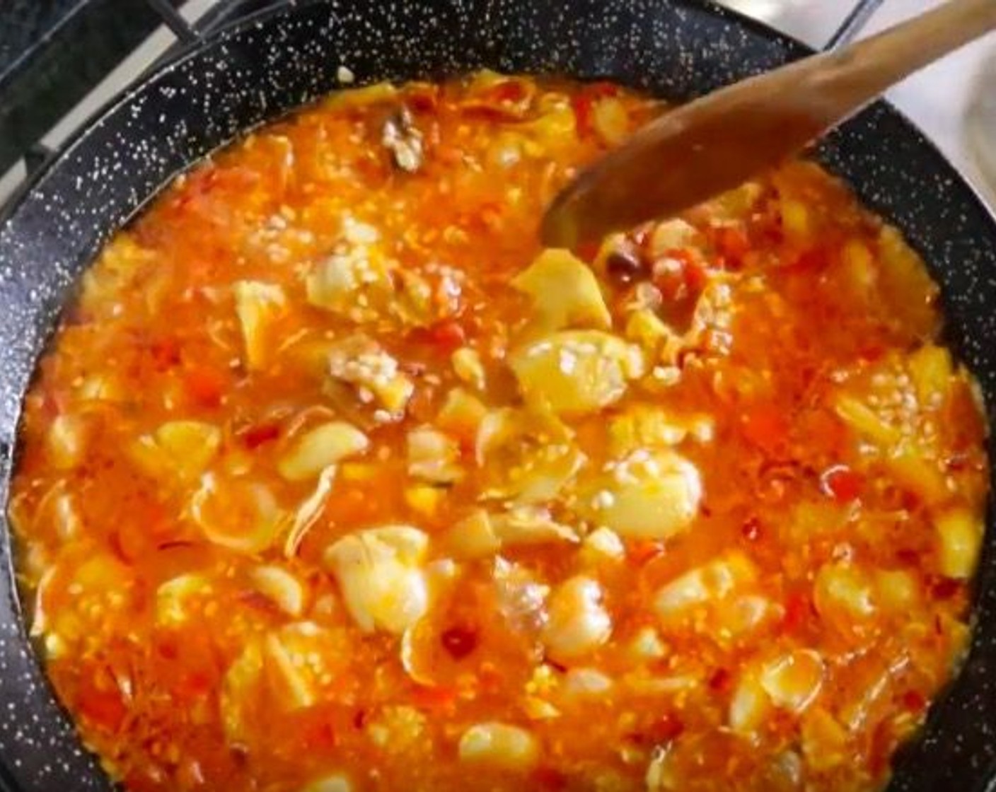 step 12 Add Water (2 1/2 cups) and Saffron Threads (1/4 tsp) and give it a gentle mix. Bring to a boil, then add Bomba Rice (1 cup) and gently distribute the rice with a wooden spoon.