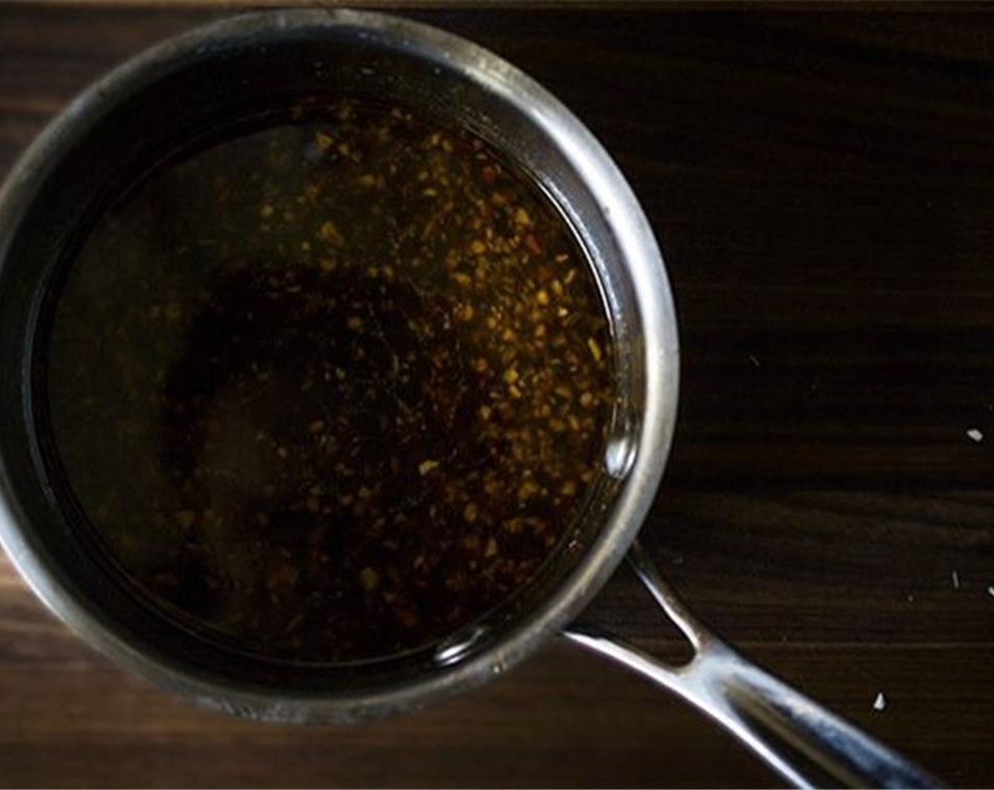step 10 Remove the pan from heat and add Crushed Red Pepper Flakes (1 tsp). Let cool for 5 to 10 minutes. Once cool, add minced Garlic (1 1/2 cloves), Worcestershire Sauce (3 Tbsp), and Fresh Ginger (1 Tbsp).