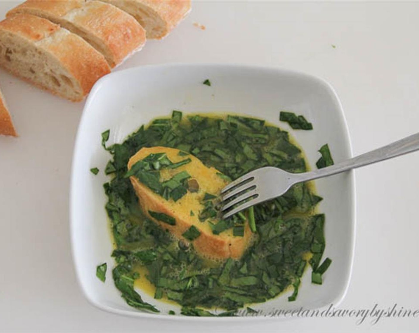 step 4 Mix chopped spinach into the eggs. Soak the slices of baguette in the egg and pierce with a fork here and there. This will help to really soak the bread with the egg mixture for a softer center. Spread the spinach evenly on the bread.
