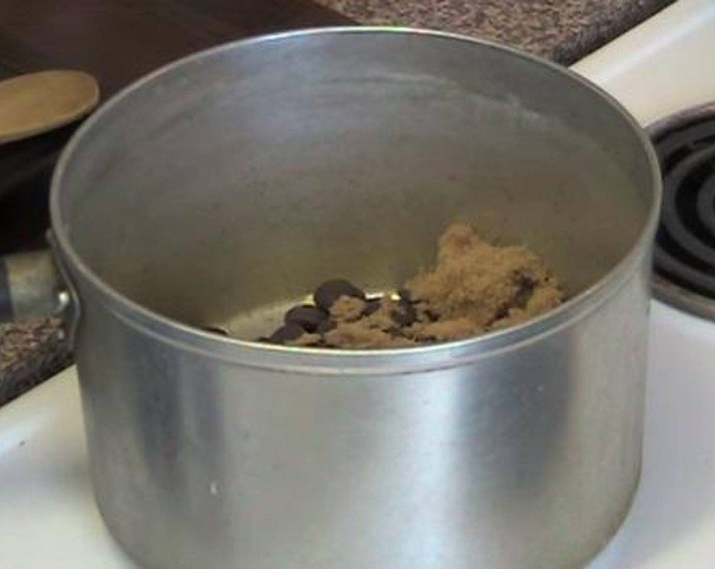 step 1 Into a sauce pan over a low heat, mix and melt together the Unsalted Butter (1/2 cup), Dark Chocolate (2/3 cup), and Brown Sugar (4 Tbsp).