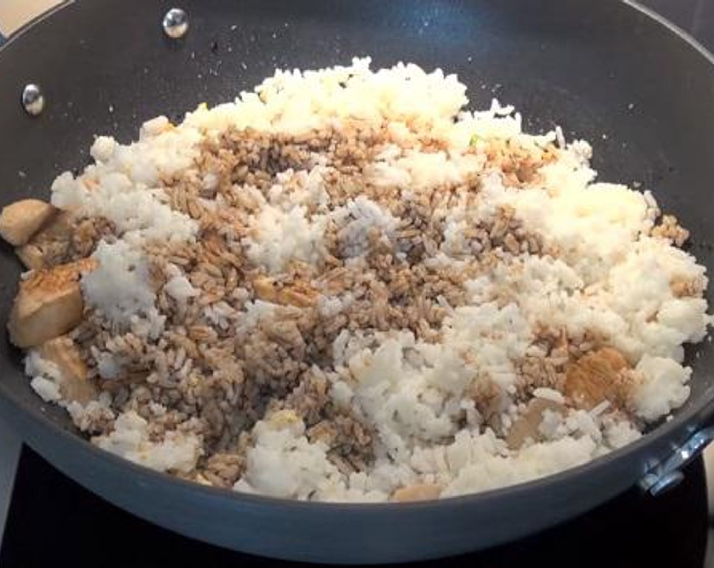 step 3 Add in the Eggs (2), and cook for a few minutes. Then, add in the chicken, and cooked White Rice (1 cup) into the wok. Sprinkle over with some Soy Sauce (4 Tbsp), and mix everything together.