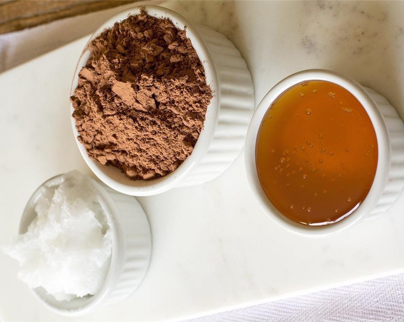 step 6 Mix the Unsweetened Cocoa Powder (4 Tbsp) in with the coconut oil, then add in the Honey (2 Tbsp) and Vanilla Extract (1 tsp) and stir until smooth, liquid-like consistency. This is the chocolate coating.