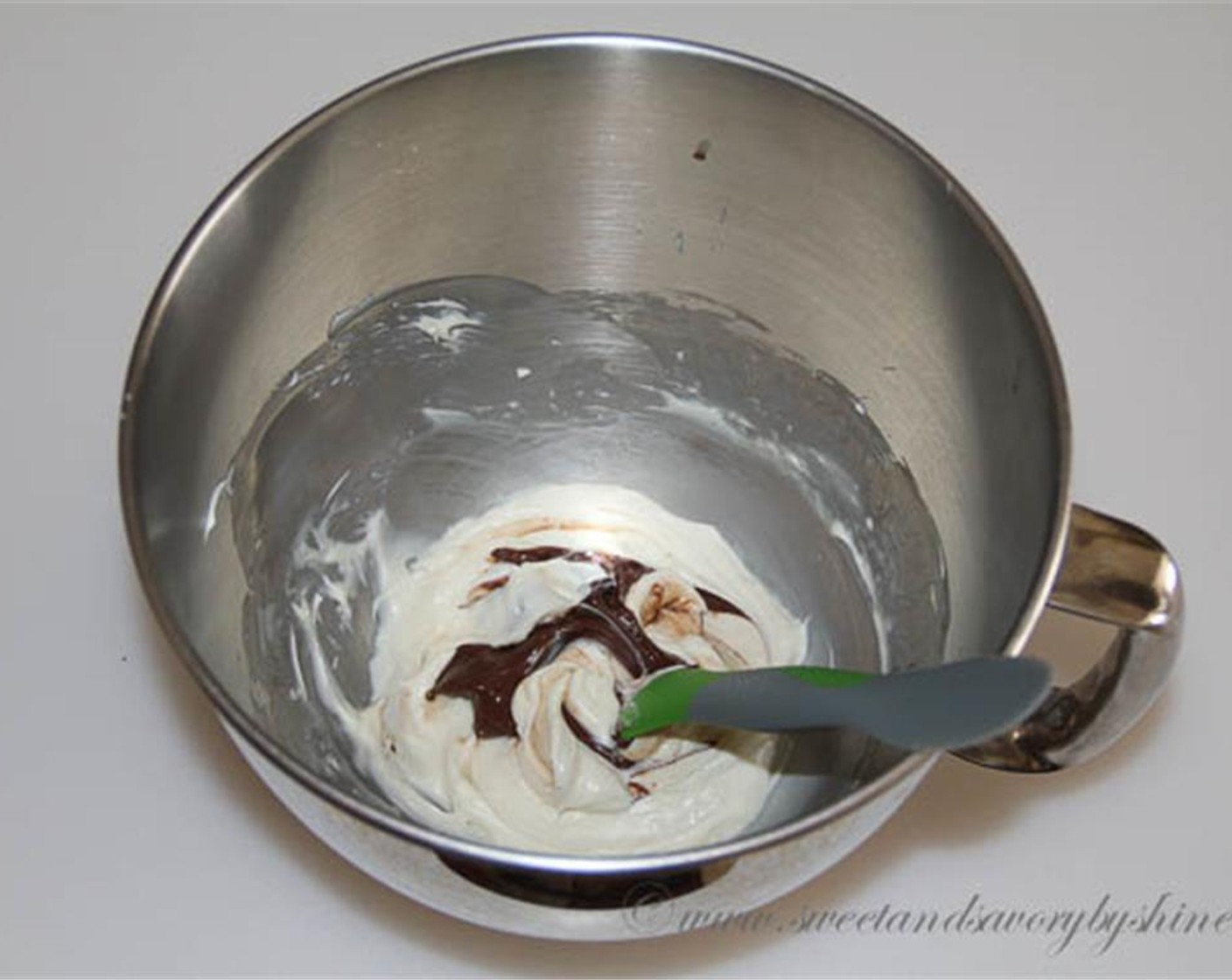 step 2 In a mixing bowl with a whisk attachment, beat the Cream Cheese (1/2 cup), Sweetened Condensed Milk (4 Tbsp) and Vanilla Extract (1/2 tsp) together until well combined. Swirl Nutella® (2 Tbsp) in to bowl to mix throughout.