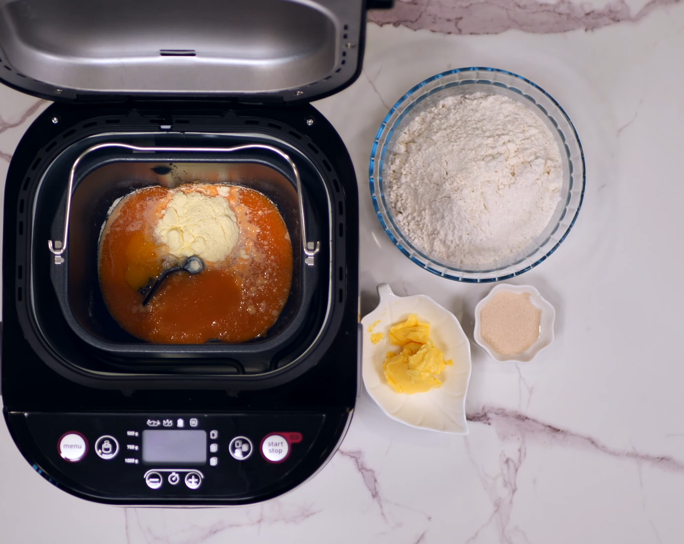 step 2 Place the pumpkin and carrot juice mixture, Egg (1), Milk Powder (2 Tbsp), Granulated Sugar (2 Tbsp), Bread Flour (2 1/3 cups), Instant Dry Yeast (1 tsp), and Salted Butter (2 Tbsp) into a breadmaker.