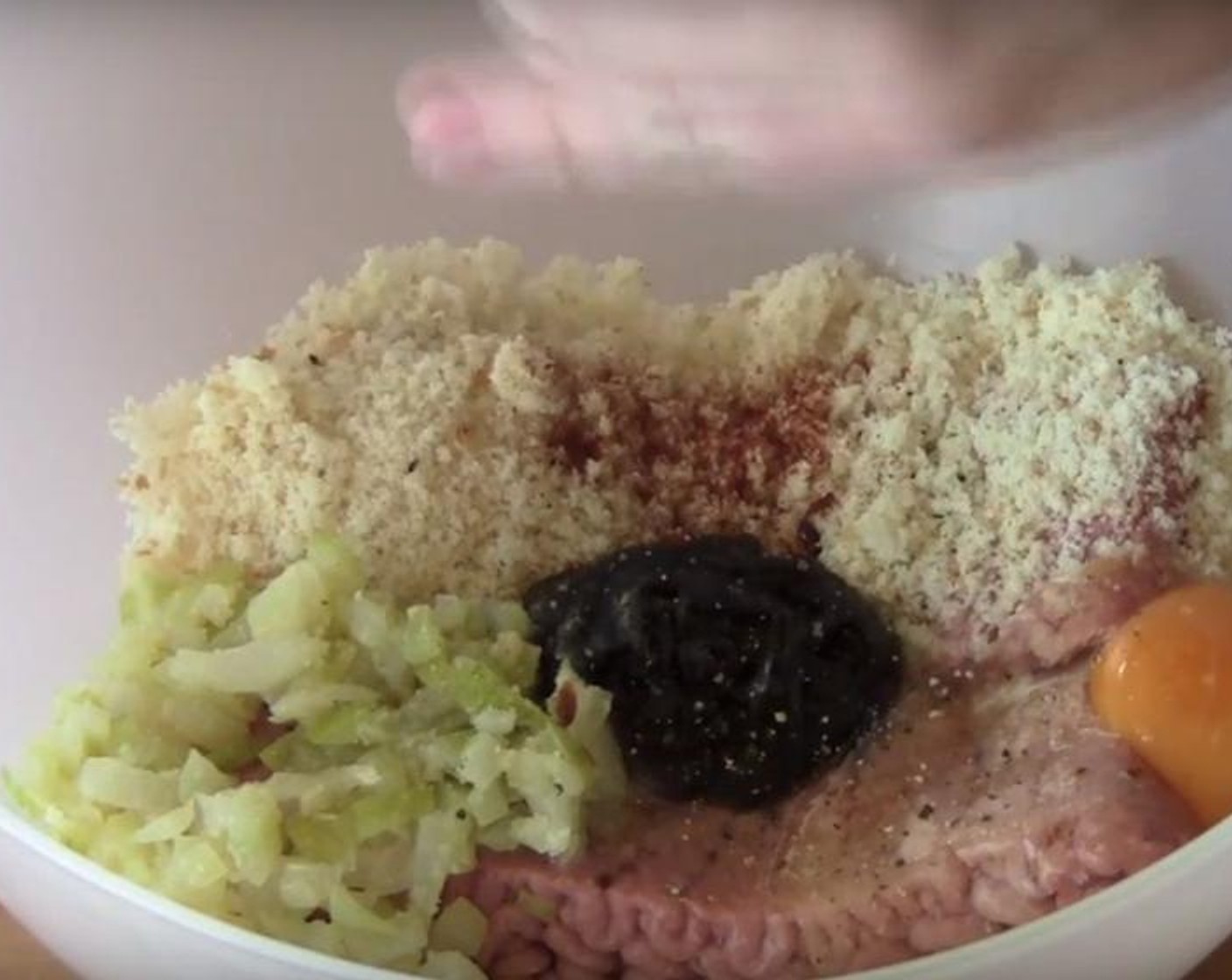 step 2 Put Turkey Breasts (1.1 lb) into a different mixing bowl. Add Breadcrumbs (1/2 cup) and the onion mixture. Pour over Barbecue Sauce (1 Tbsp). Add Mild Paprika (1/2 tsp) and Egg (1). Season with Salt (to taste) and Ground Black Pepper (to taste). Mix everything together with your hands. Divide the mixture into six patties.