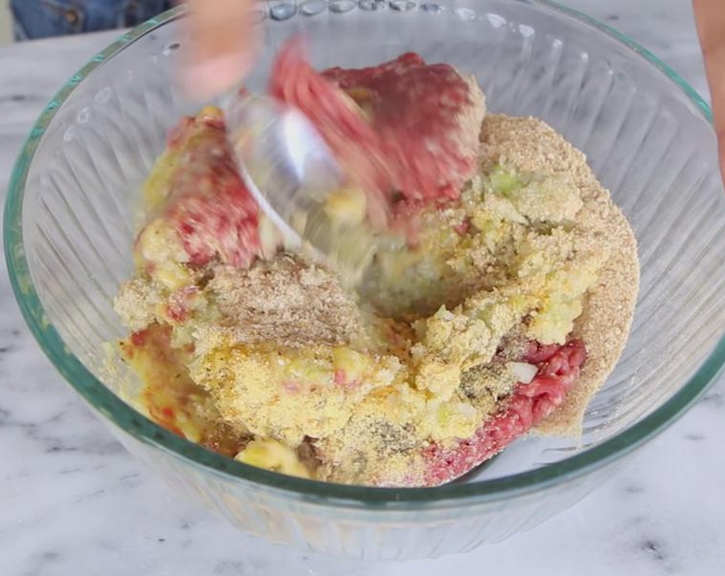 step 2 Add Lean Ground Beef (1 lb), processed vegetables, Breadcrumbs (4 Tbsp), Ground Black Pepper (1/4 tsp), Egg (1), Chicken Bouillon Powder (2 tsp), and Dried Oregano (1/2 tsp) to a bowl. Use a spoon to mix.