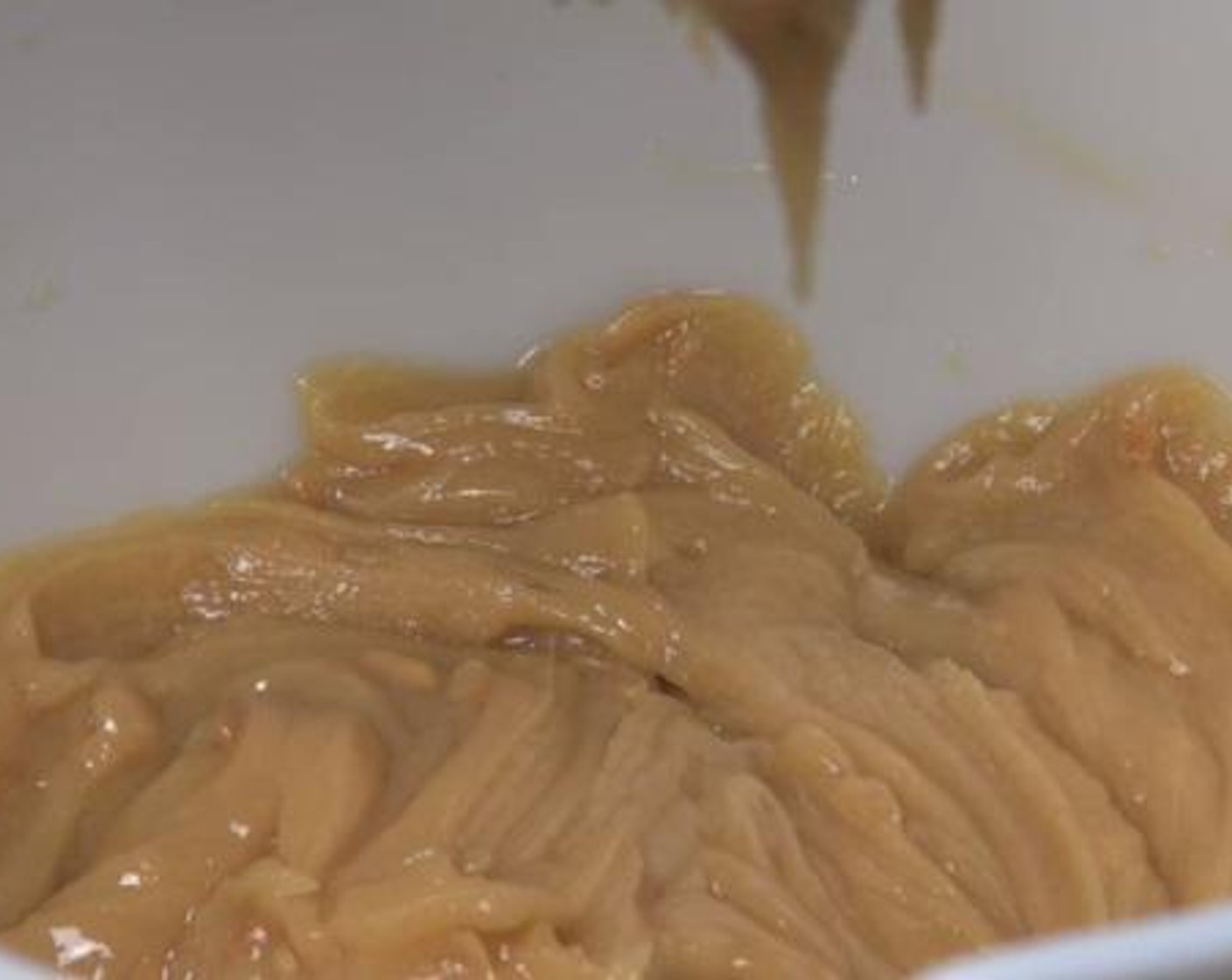 step 2 Into a large mixing bowl, beat the Cream Cheese (1/2 cup) until it's fluffy. Then add in the Powdered Confectioners Sugar (2 cups), Vanilla Extract (1 tsp), Salt (1 pinch), and the peanut mixture. Combine everything well.