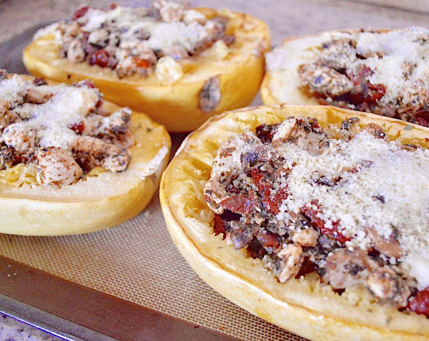 step 6 Divide the chicken mixture evenly among the squash boats and stuff them well. Finally, top each stuffed squash with Grated Parmesan Cheese (4 Tbsp). Put it back into the oven to meld together for 6-8 minutes.
