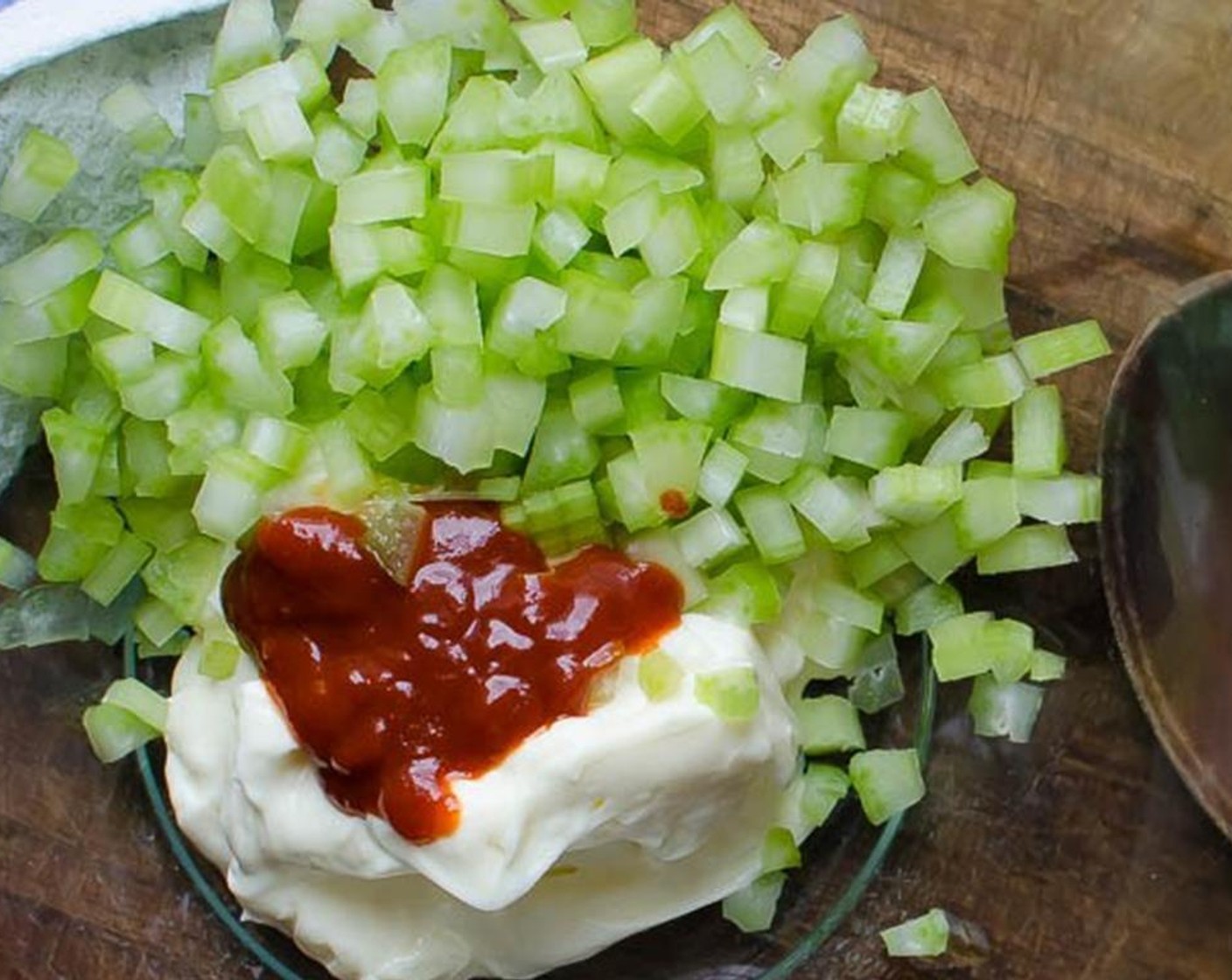 step 4 Dice the Celery (1 stalk). In a large bowl, combine the Mayonnaise (1/2 cup), celery, Sriracha (2 tsp), zest and juice from Lime (1/3), Kosher Salt (1/4 tsp), Fresh Cilantro (2 Tbsp) and Freshly Ground Black Pepper (to taste).