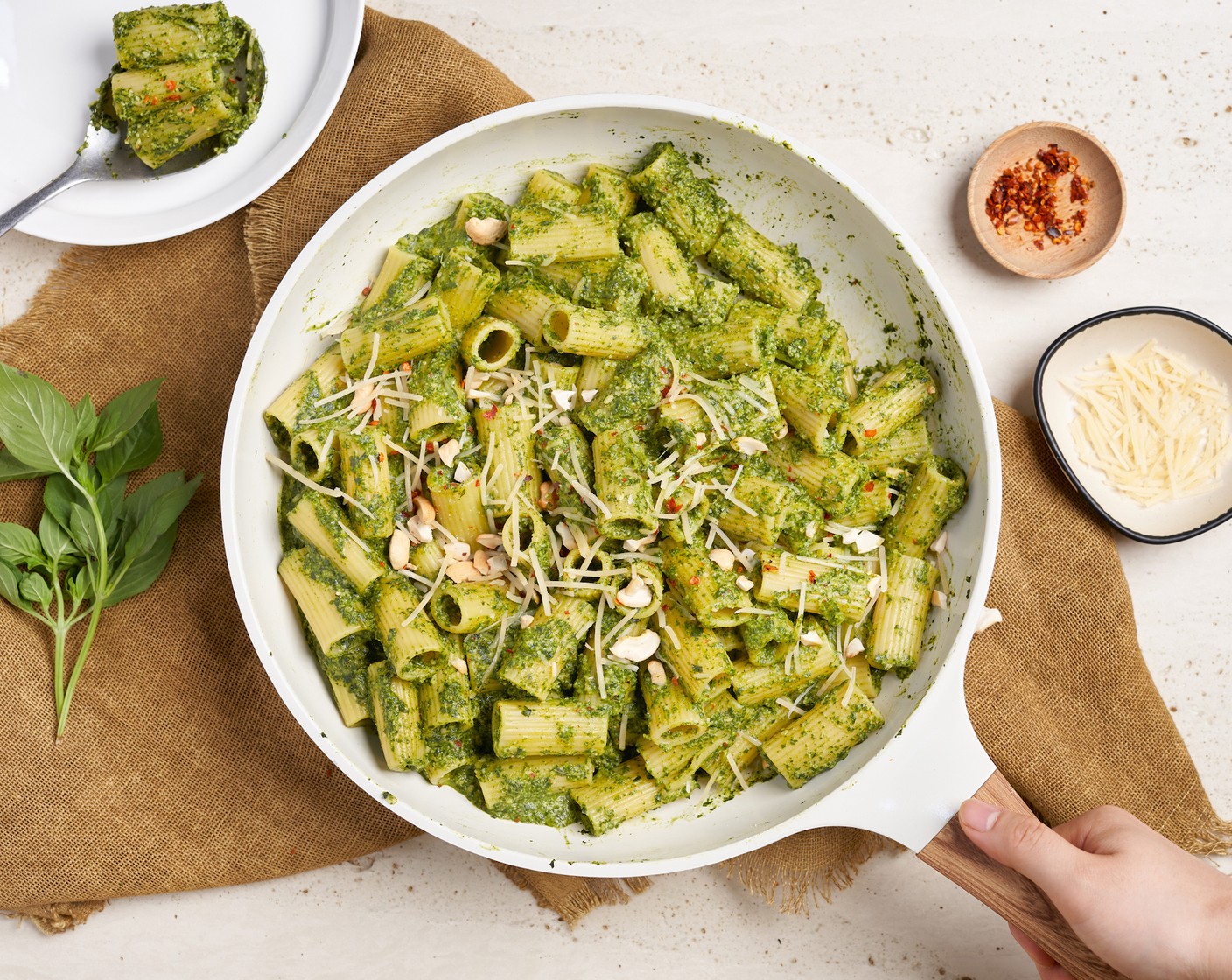 step 5 Spoon the pasta into a serving bowl, top with more parmesan cheese and sprinkle some chopped cashew and red chili flakes. Then serve.