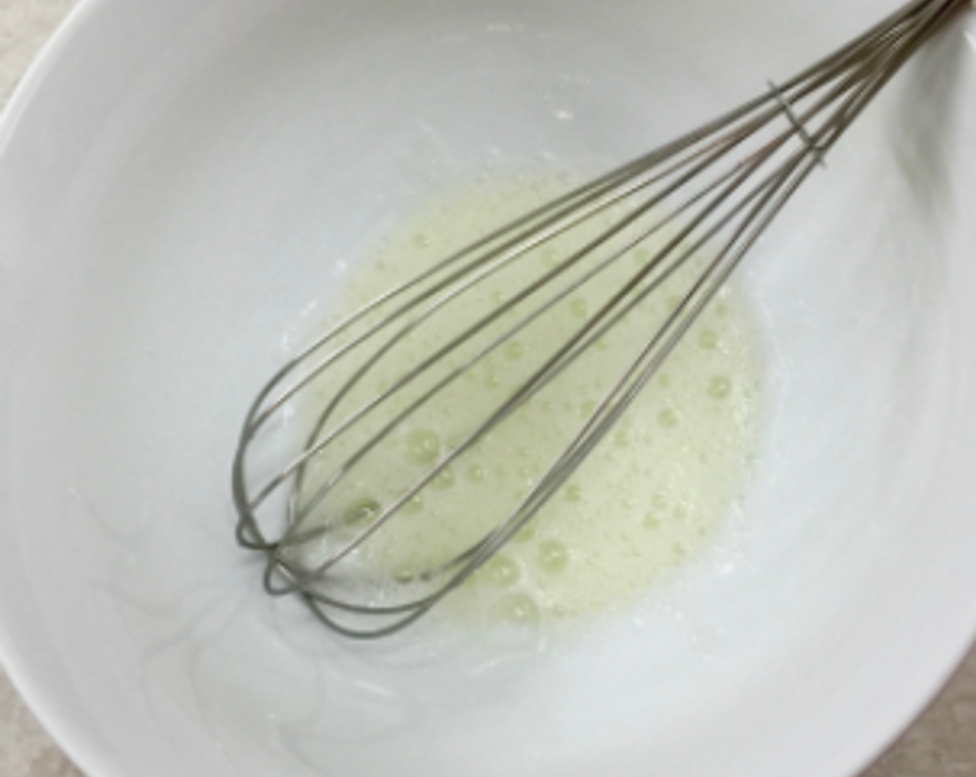 step 17 Put the egg white in a large bowl and whisk it until it's nice and frothy.